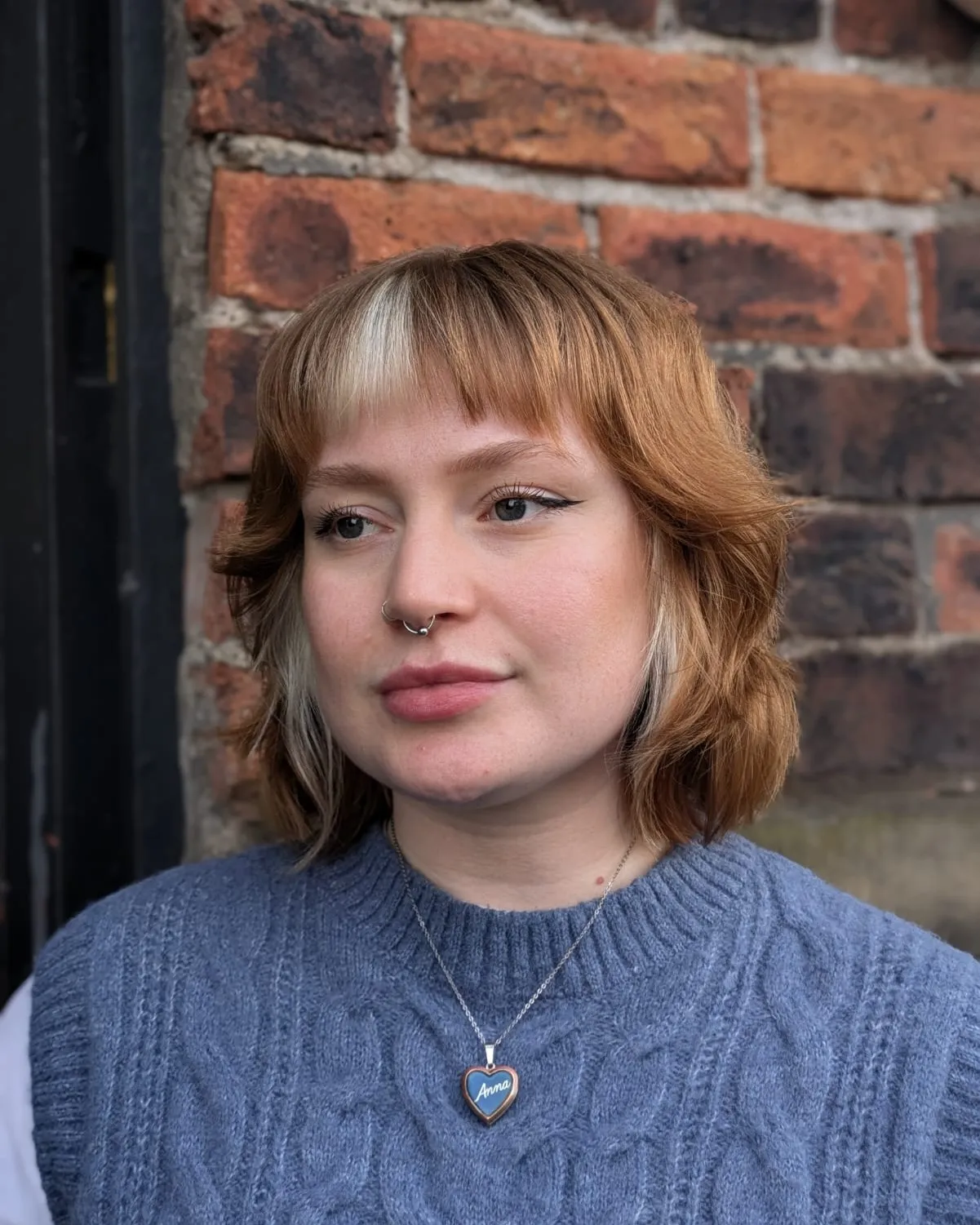 Neck-length shaggy bob with short fringe and flicked layered ends
