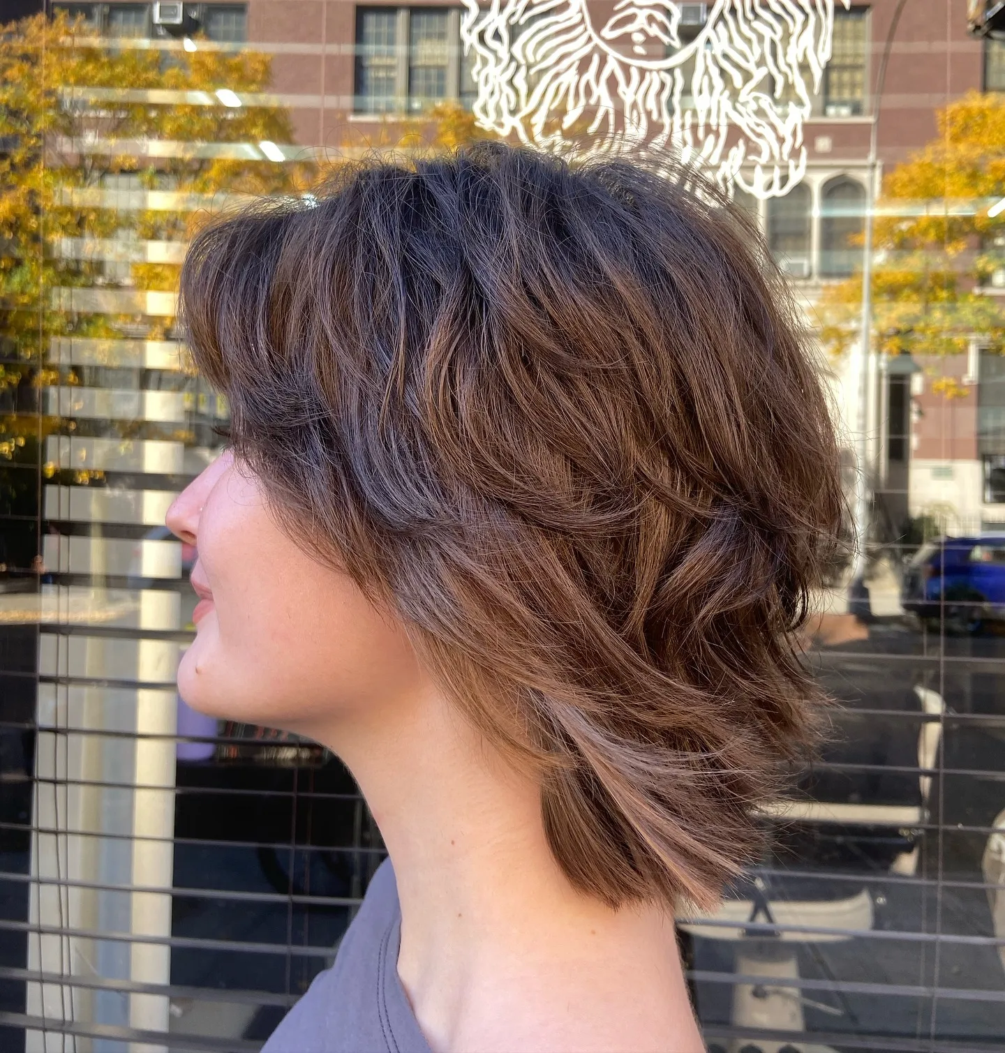 Long shaggy bob with side-swept fringe and feathered neck-length layers