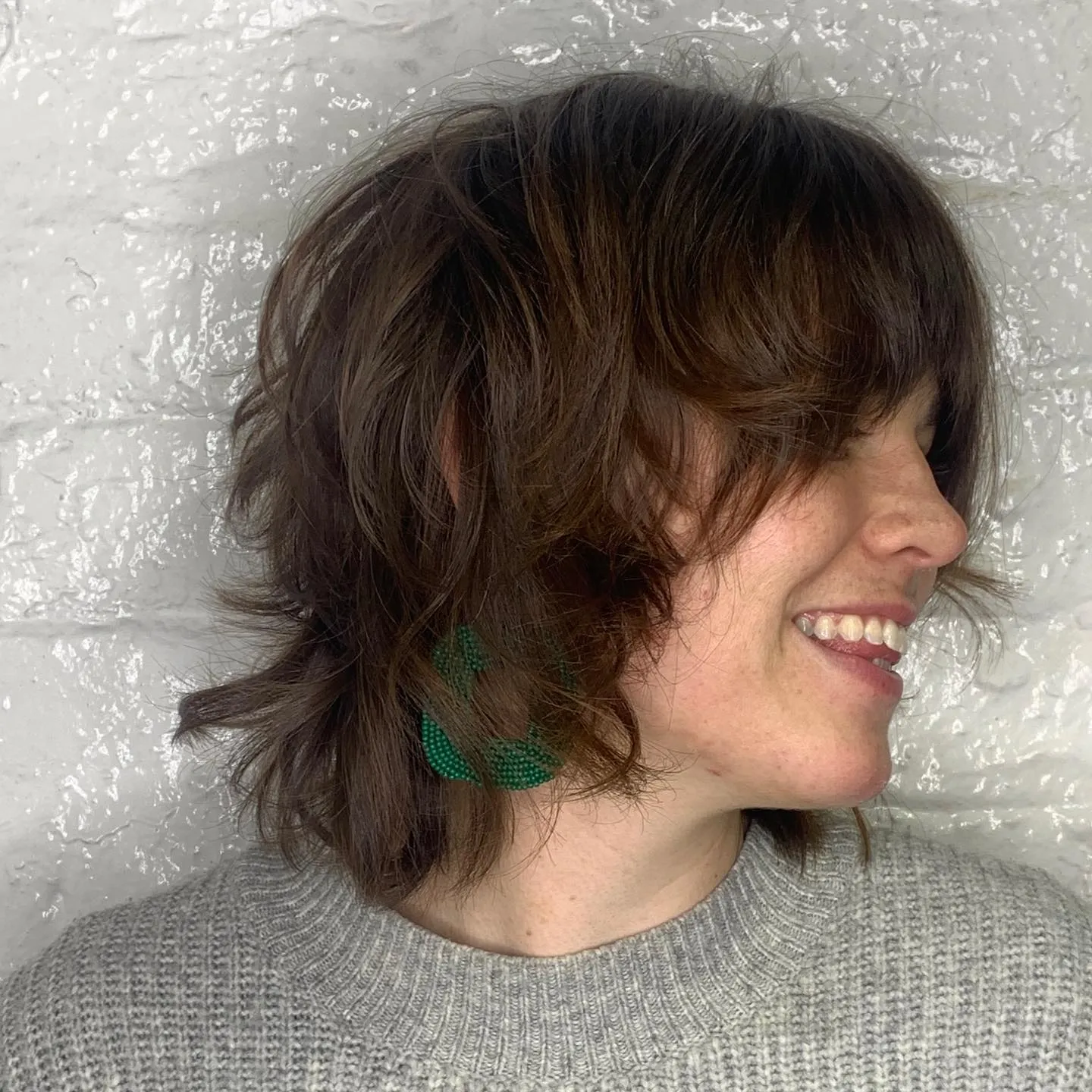 Layered shaggy bob with curtain fringe and flipped neck-length ends