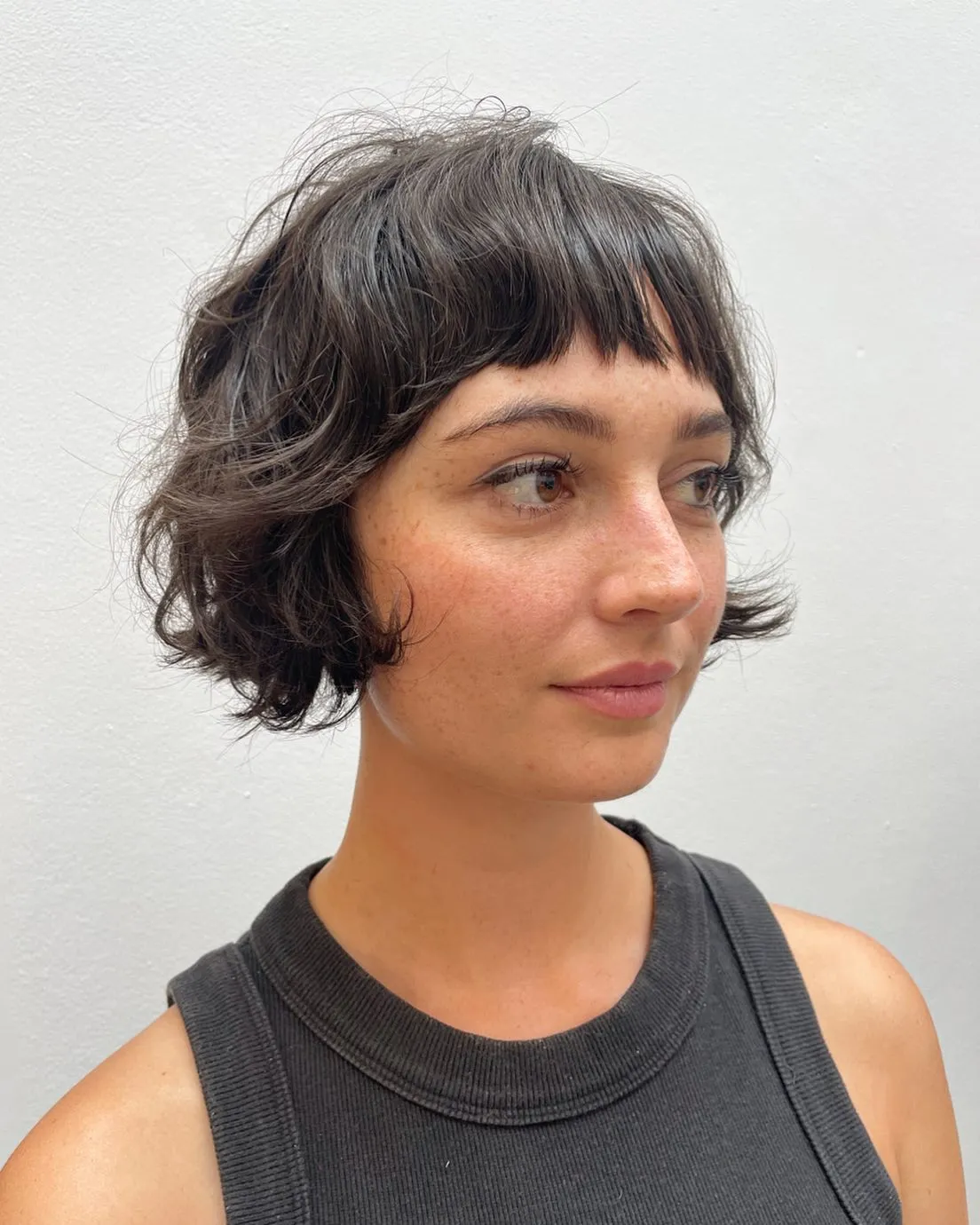 Wavy micro bob with blunt short fringe and softly flipped ends