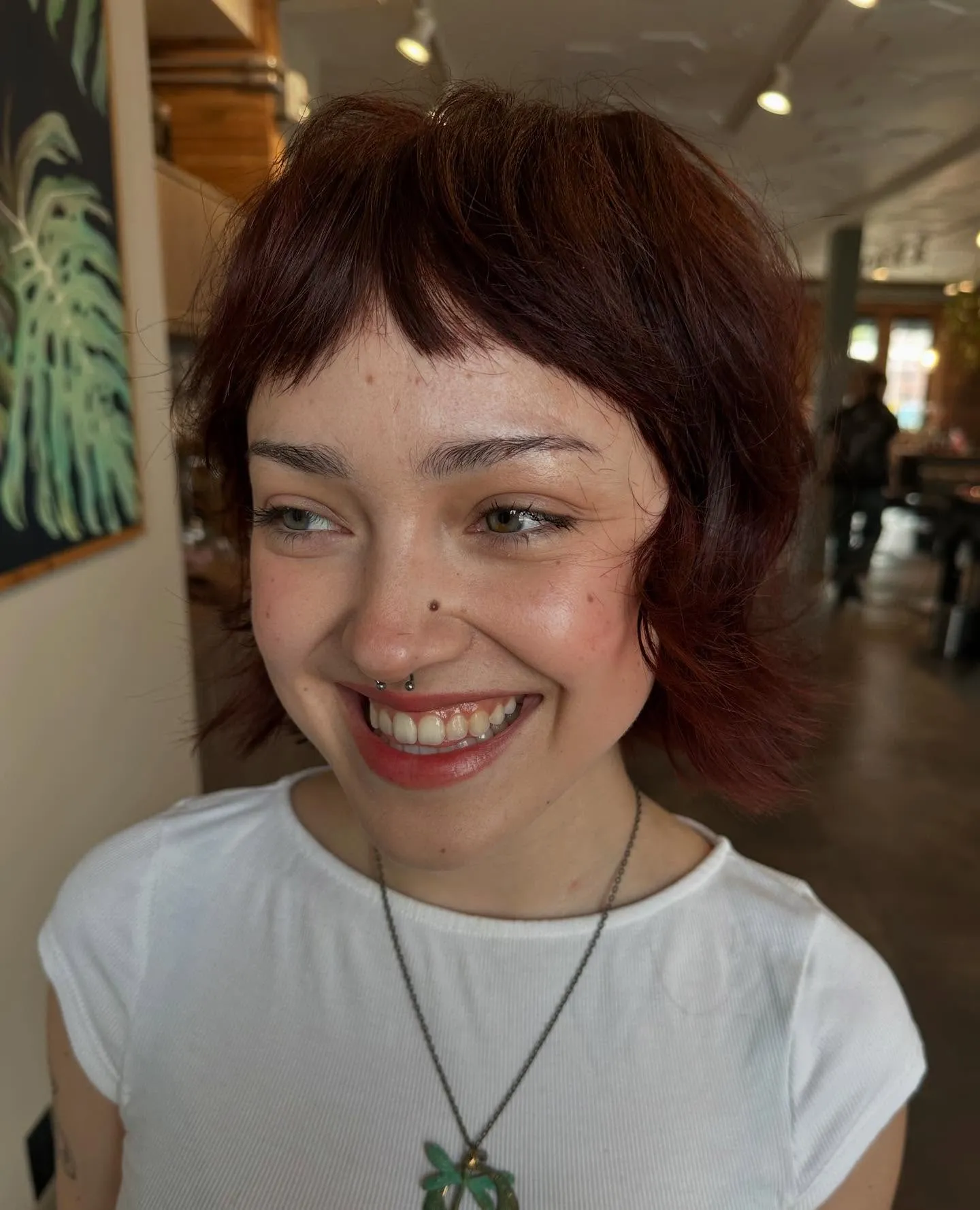 Short shaggy crop with baby fringe and razored pieces around the ears and nape