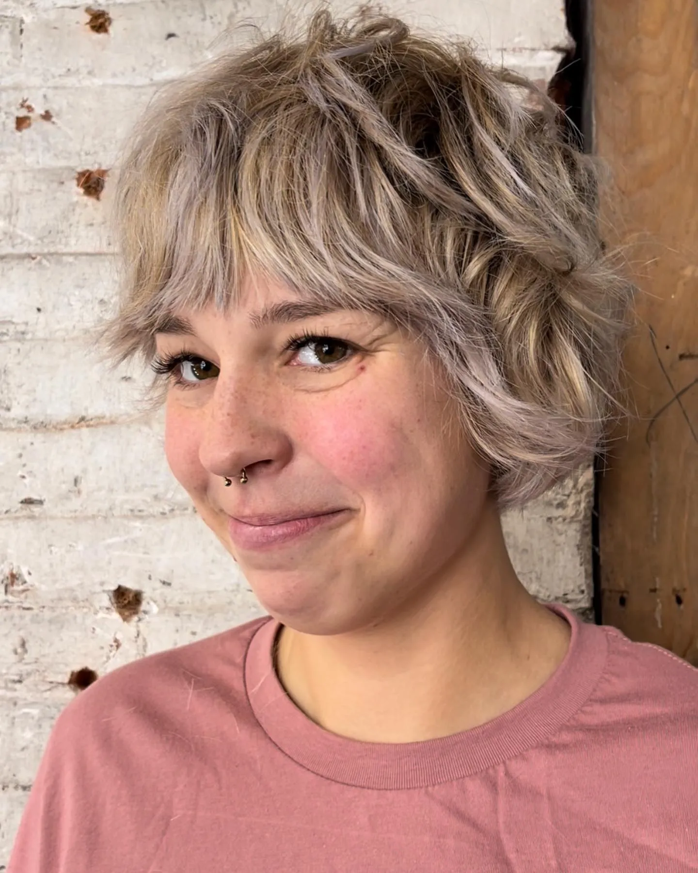 Textured pixie bob with choppy fringe and soft feathered layers