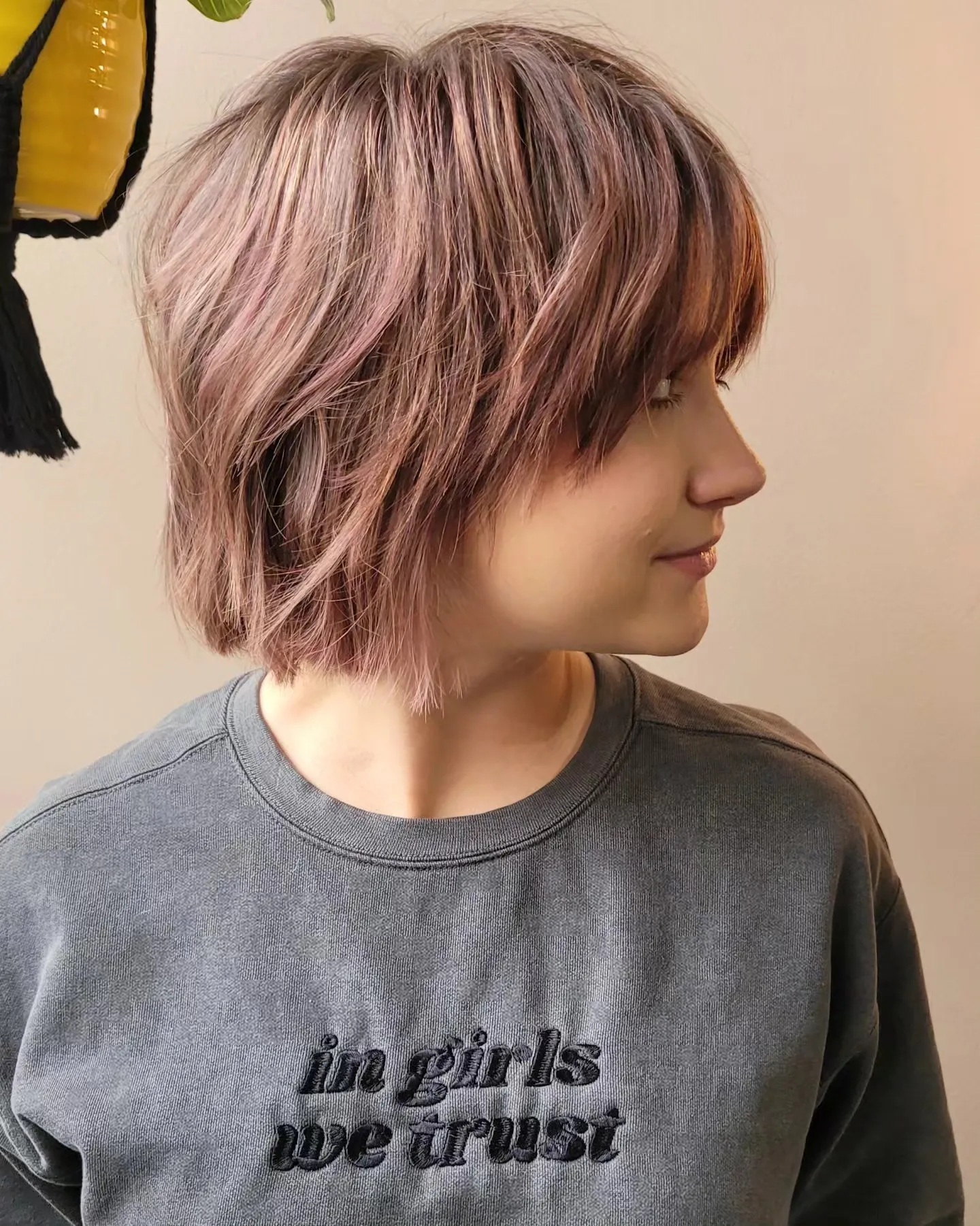 Angled shaggy bob with side-swept fringe and layered tapered nape