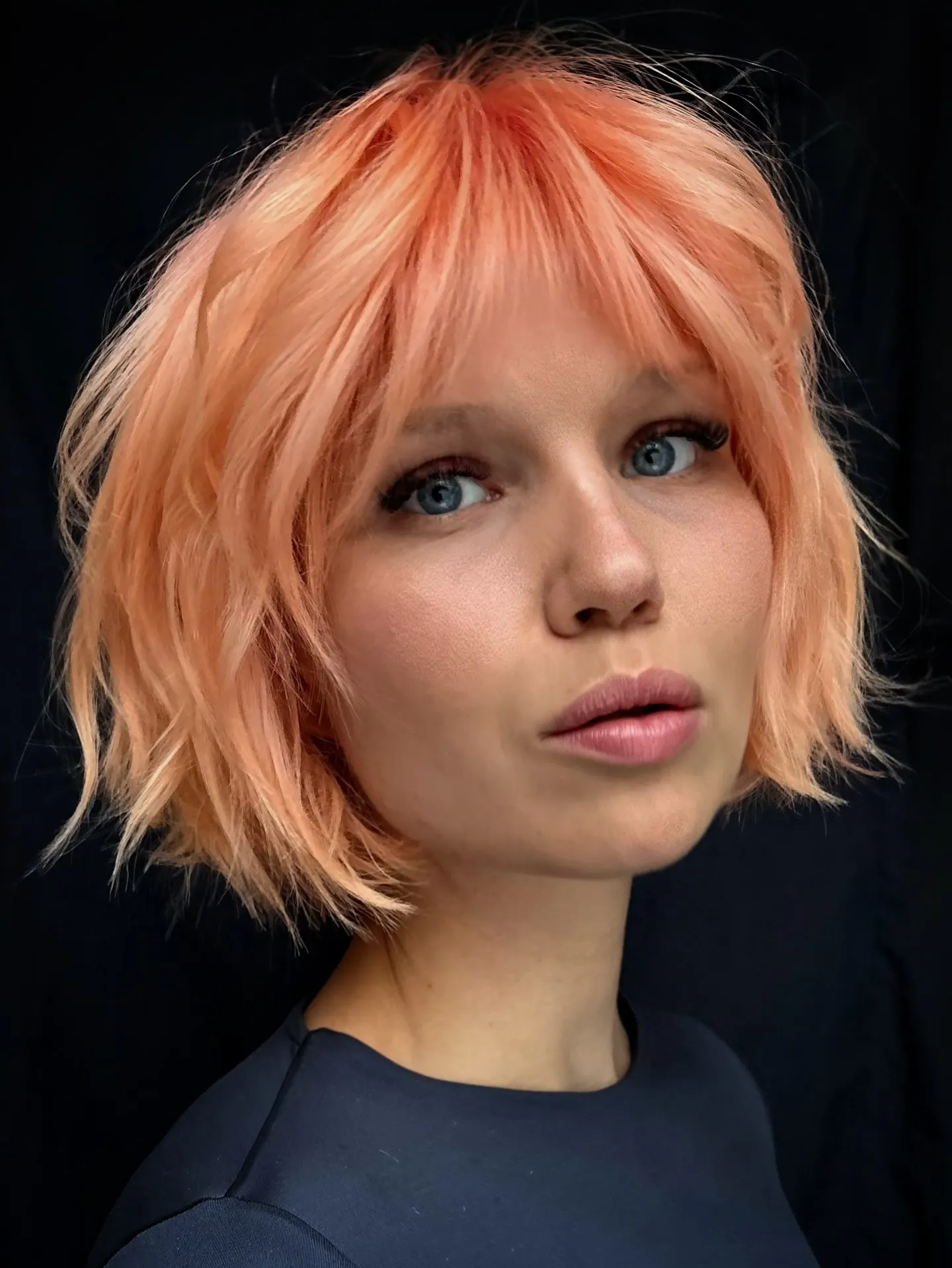 Piecey short bob with full straight fringe and tousled jaw-length ends