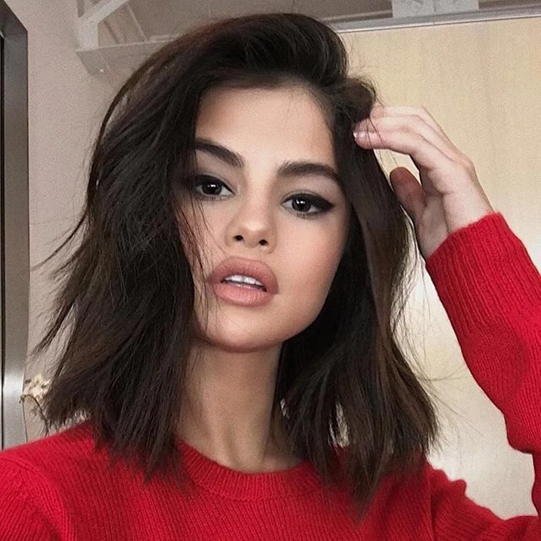 Voluminous tousled lob with a deep side part and textured shoulder-length ends