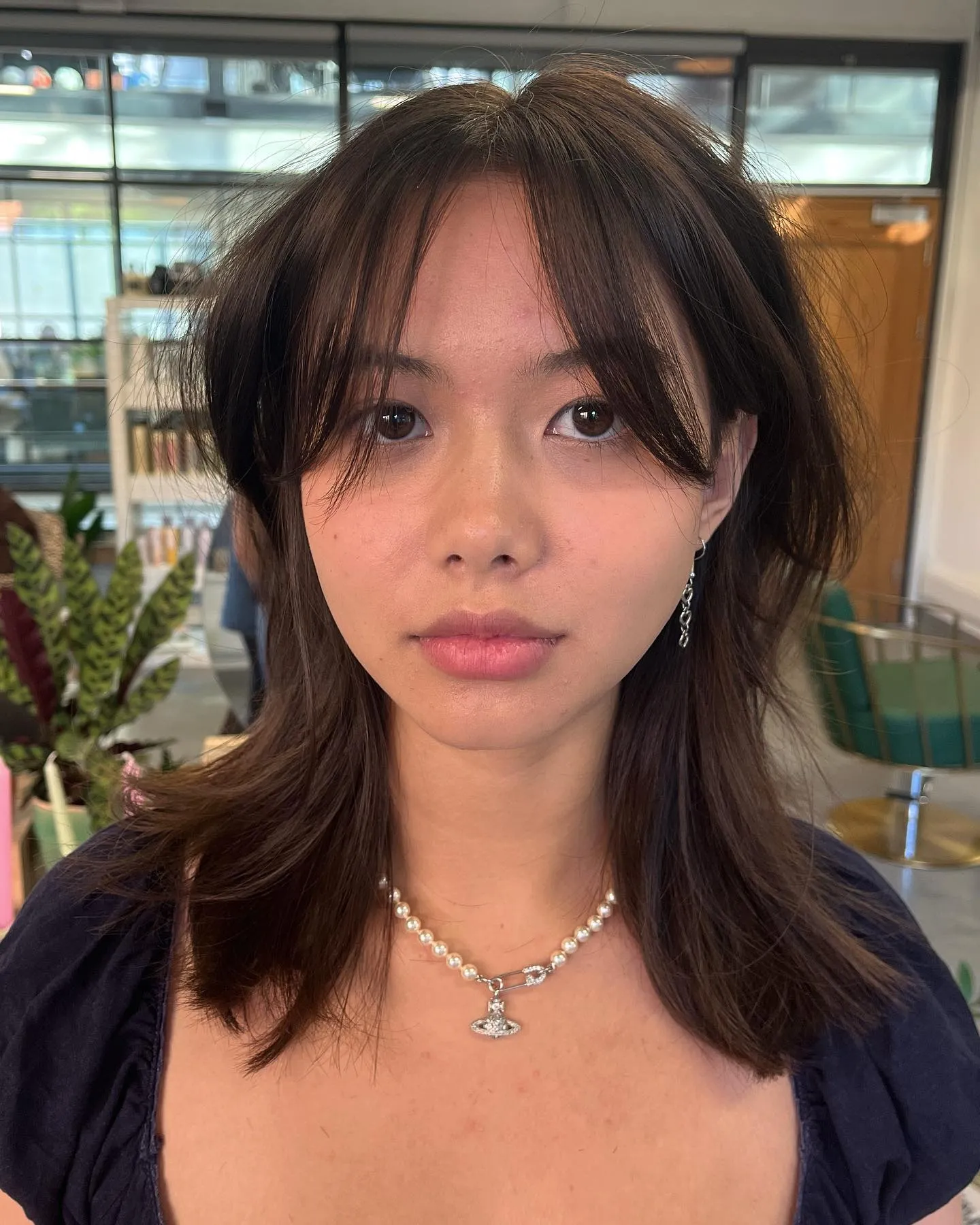 Layered shoulder-length haircut with curtain fringe and feathered ends