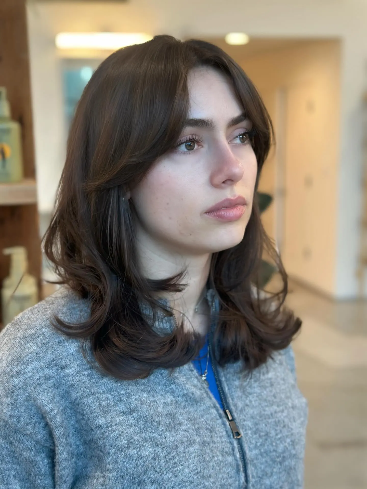 Shoulder-length butterfly layers with curtain fringe and softly flipped ends