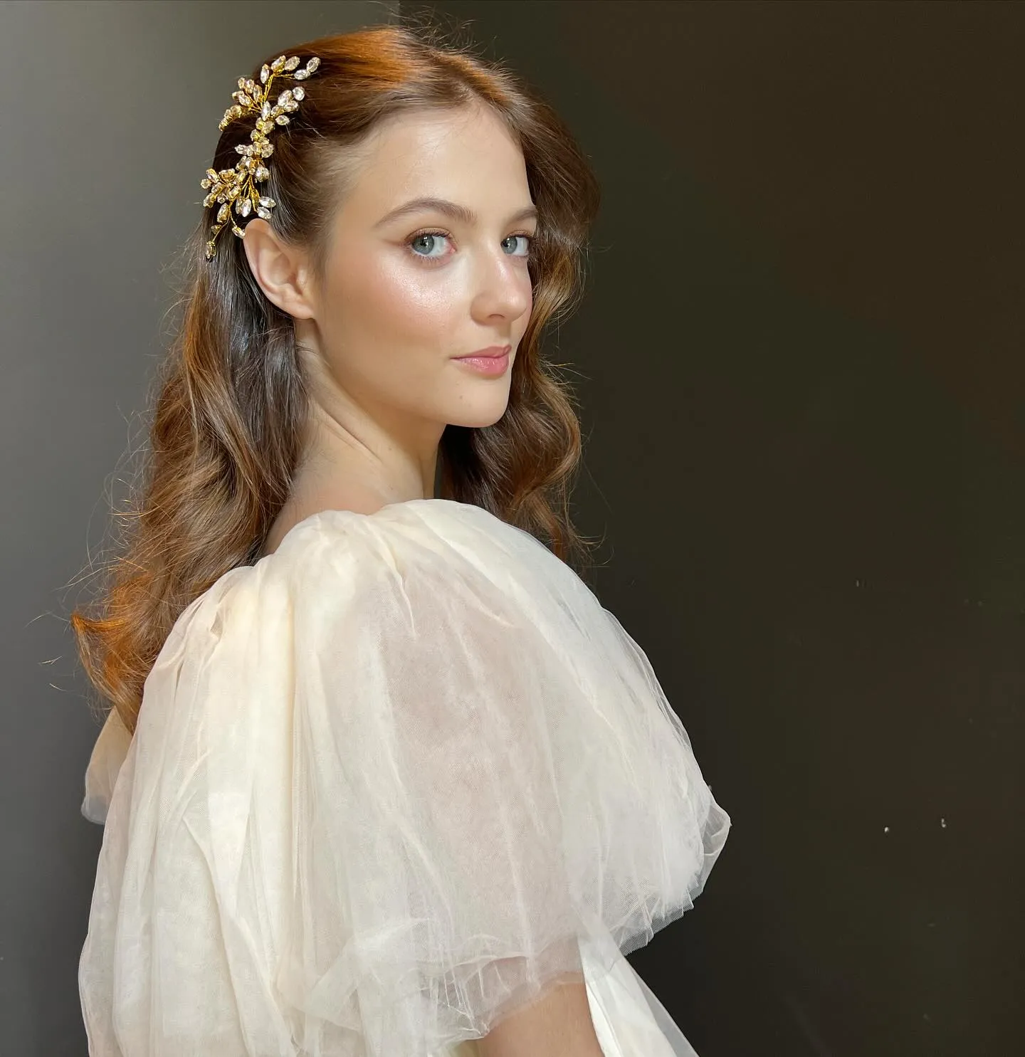 Long side-swept waves pinned with a gold vine clip