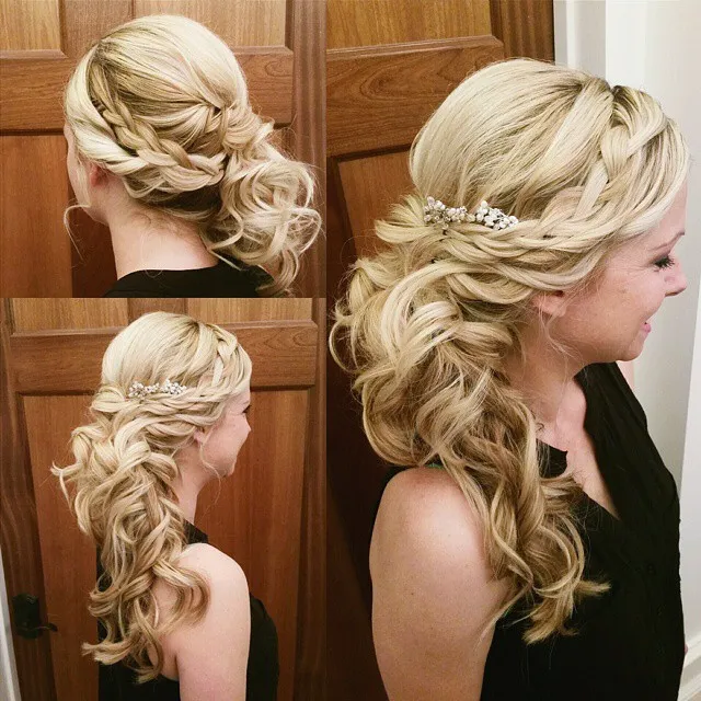 Blonde braided side ponytail with a small floral hairpiece