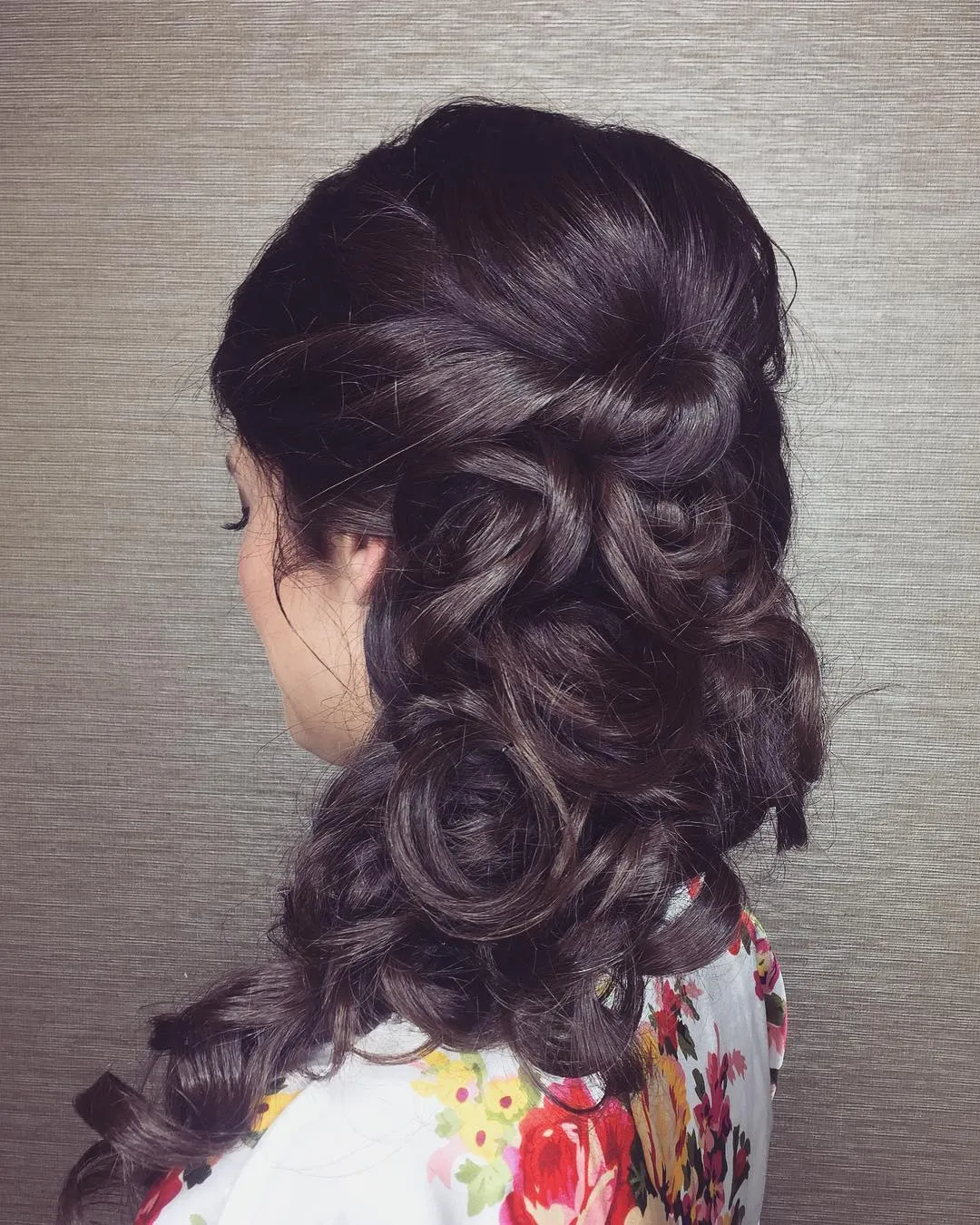 Dark sculpted side curls with twisted pinned sections