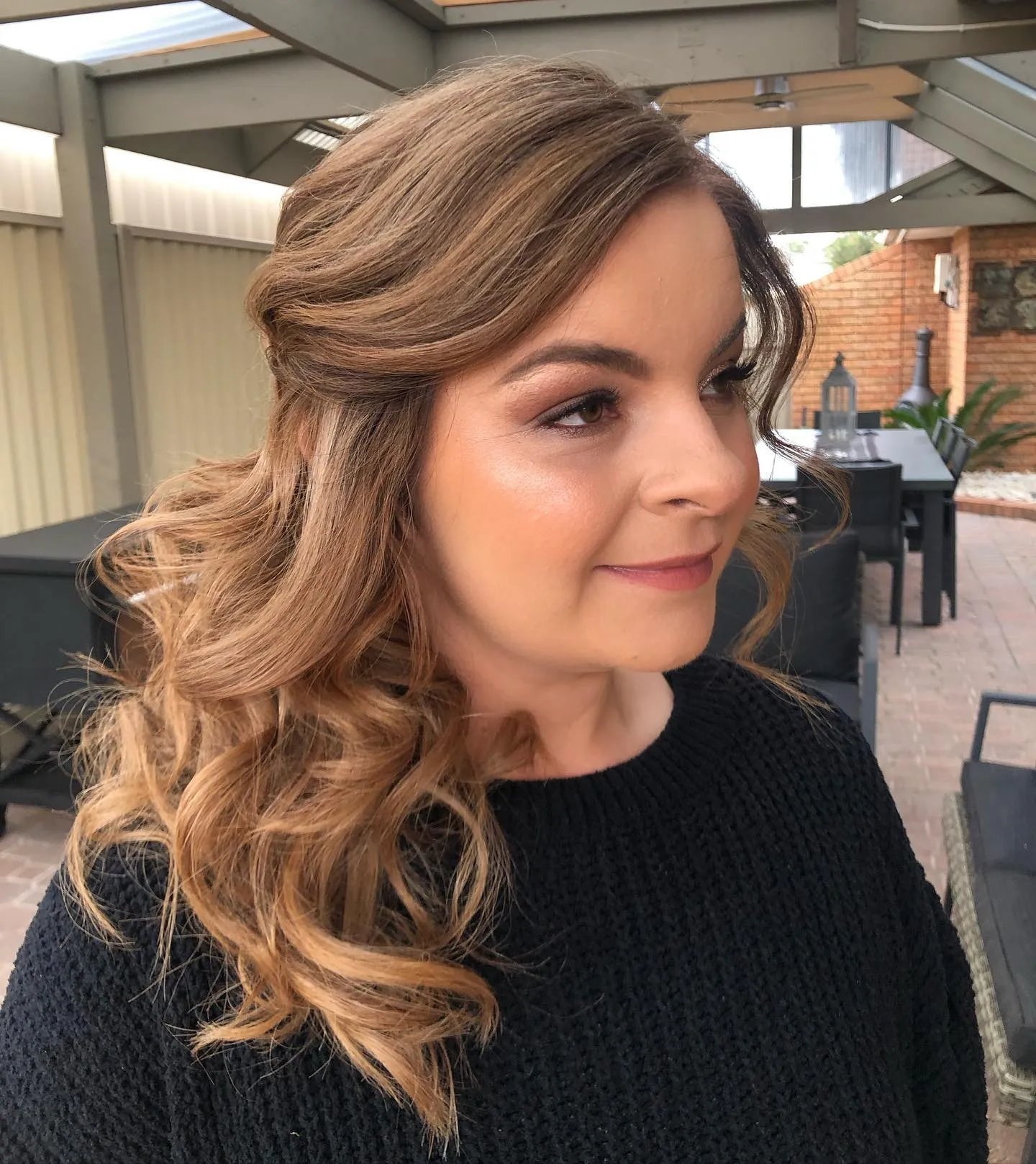 Loose side-swept curls with soft face-framing pieces
