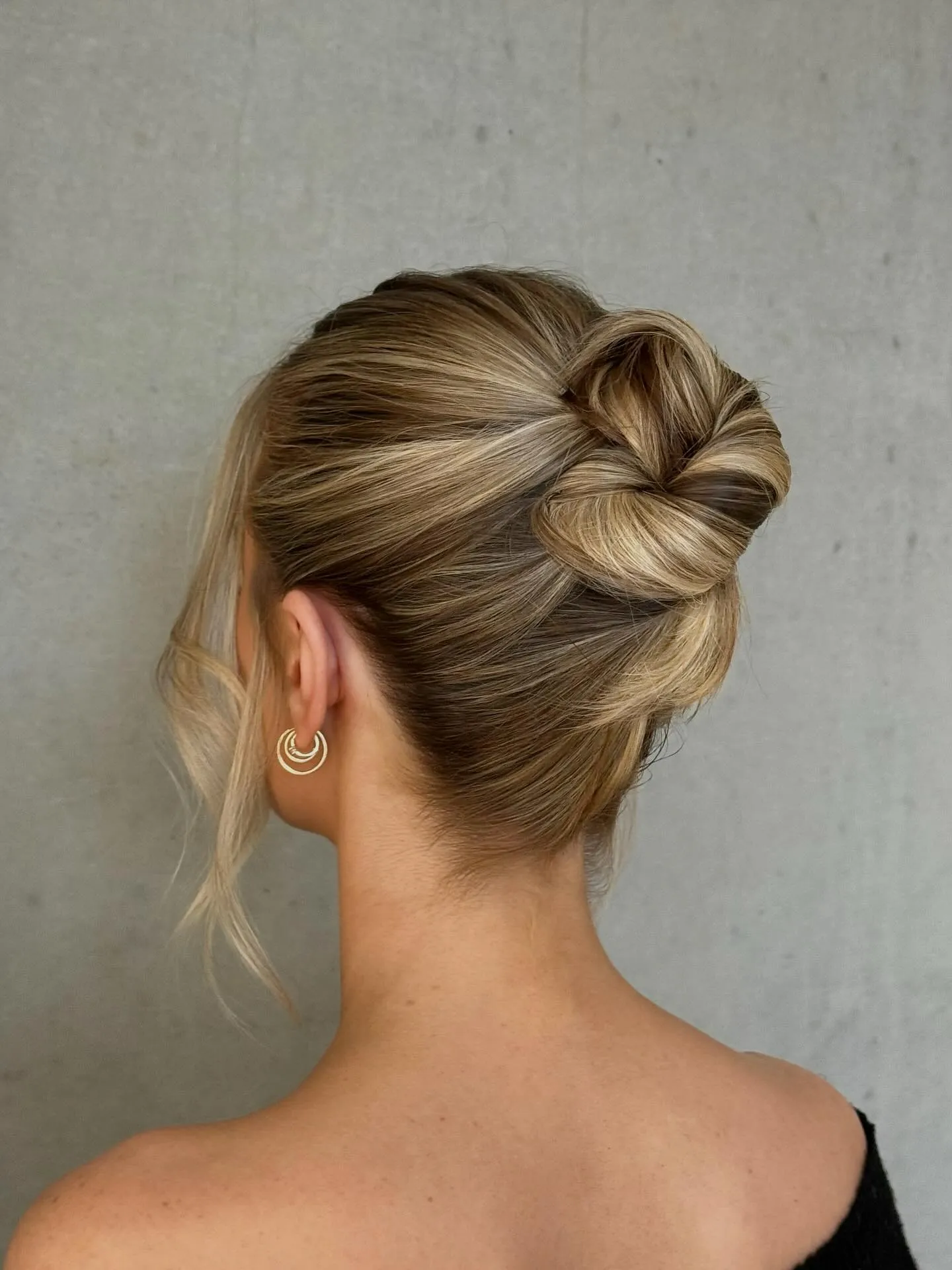 Blonde bridal high bun with smooth wrapped sections