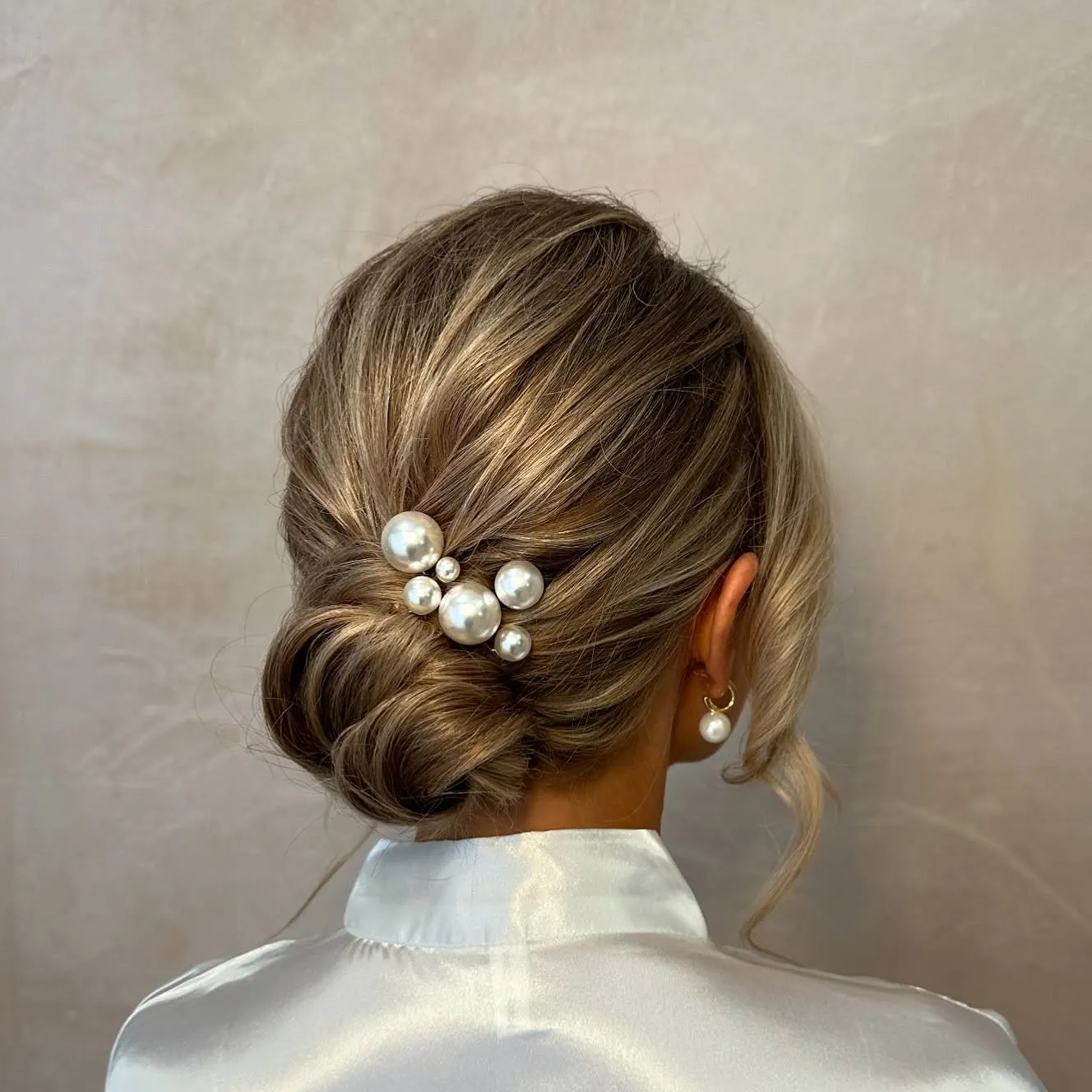 Brunette bridal low knot with clustered pearl hair pins