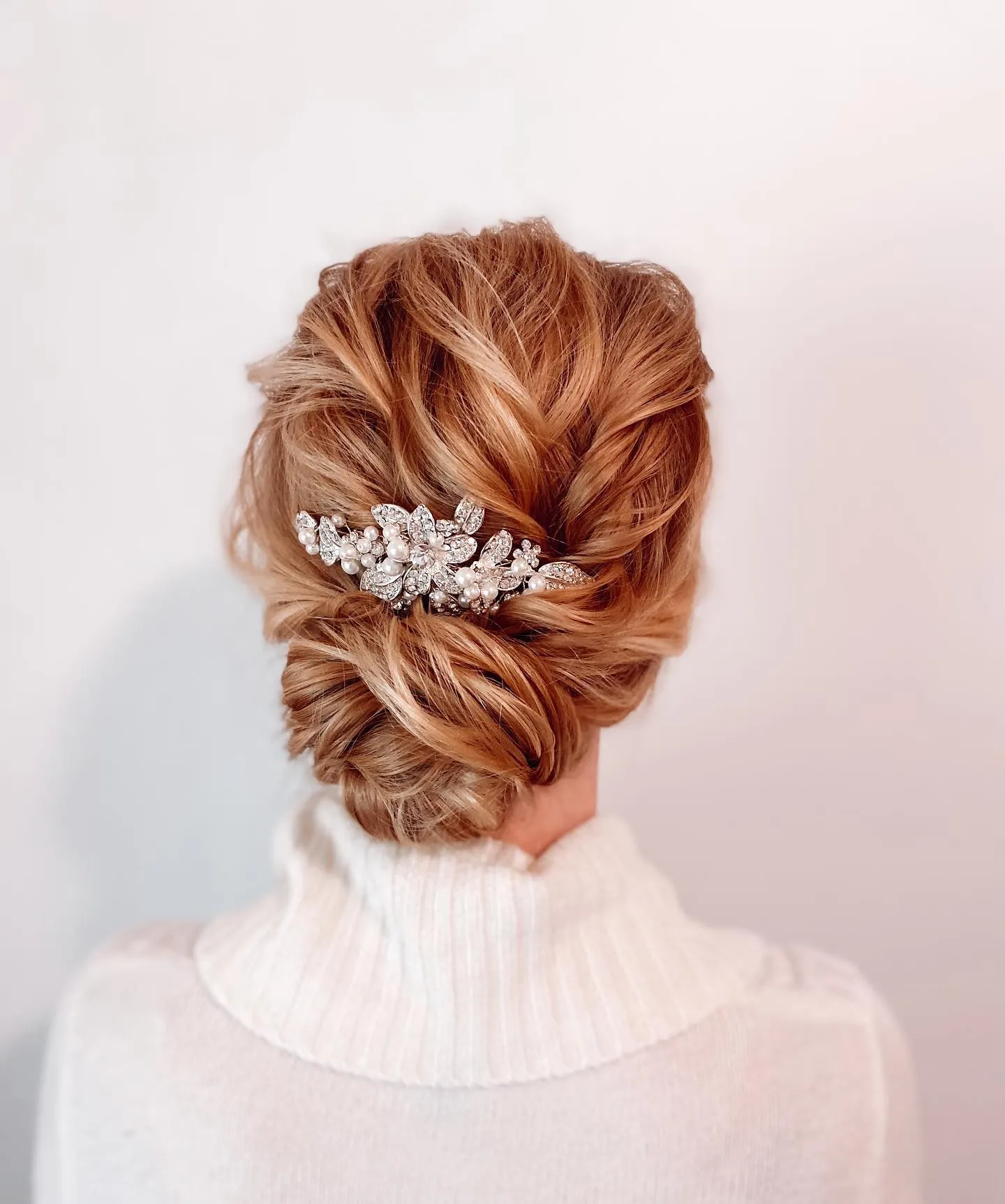 Copper bridal updo with textured twists and a crystal comb
