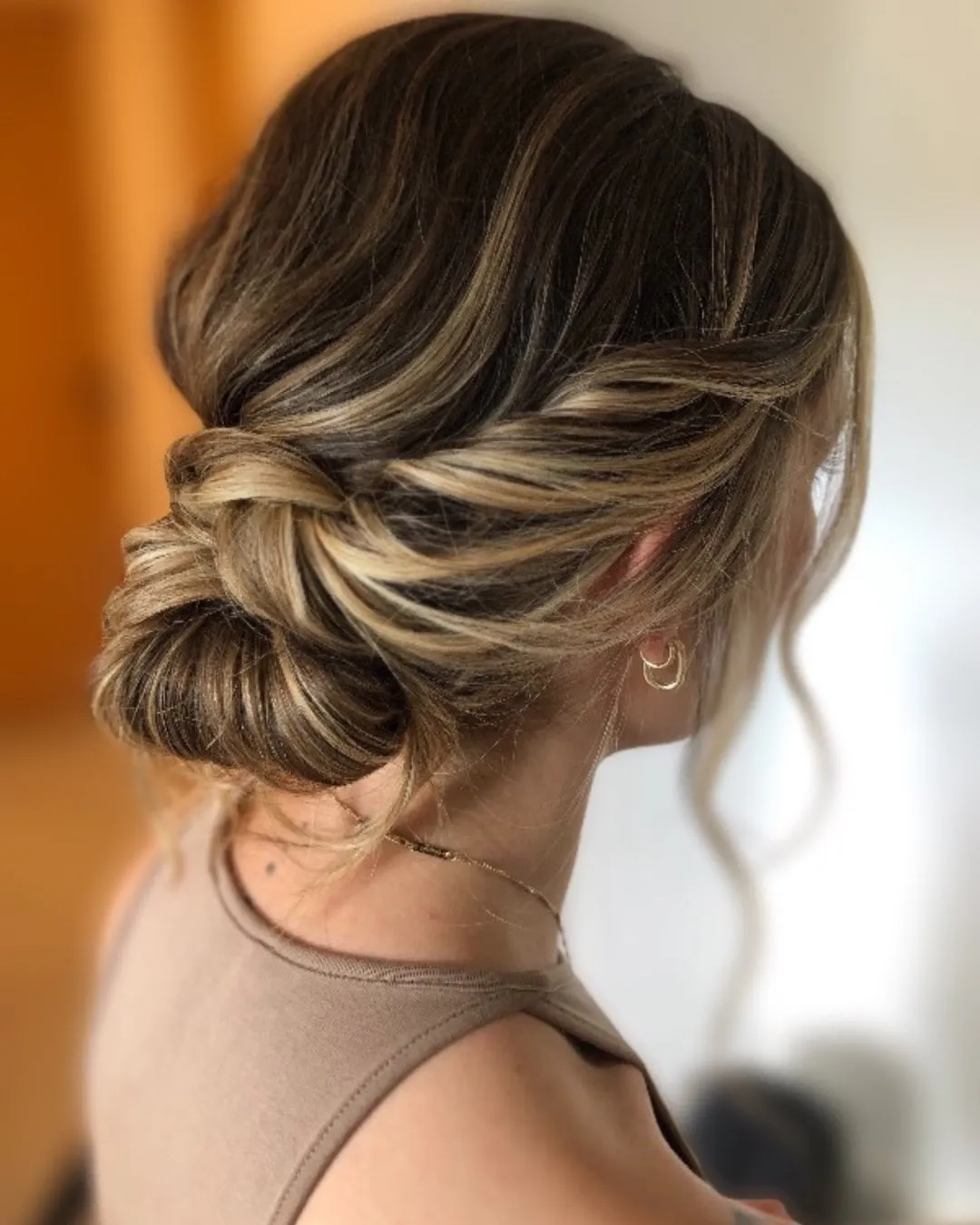 Brunette loose twisted chignon with softly pulled sections