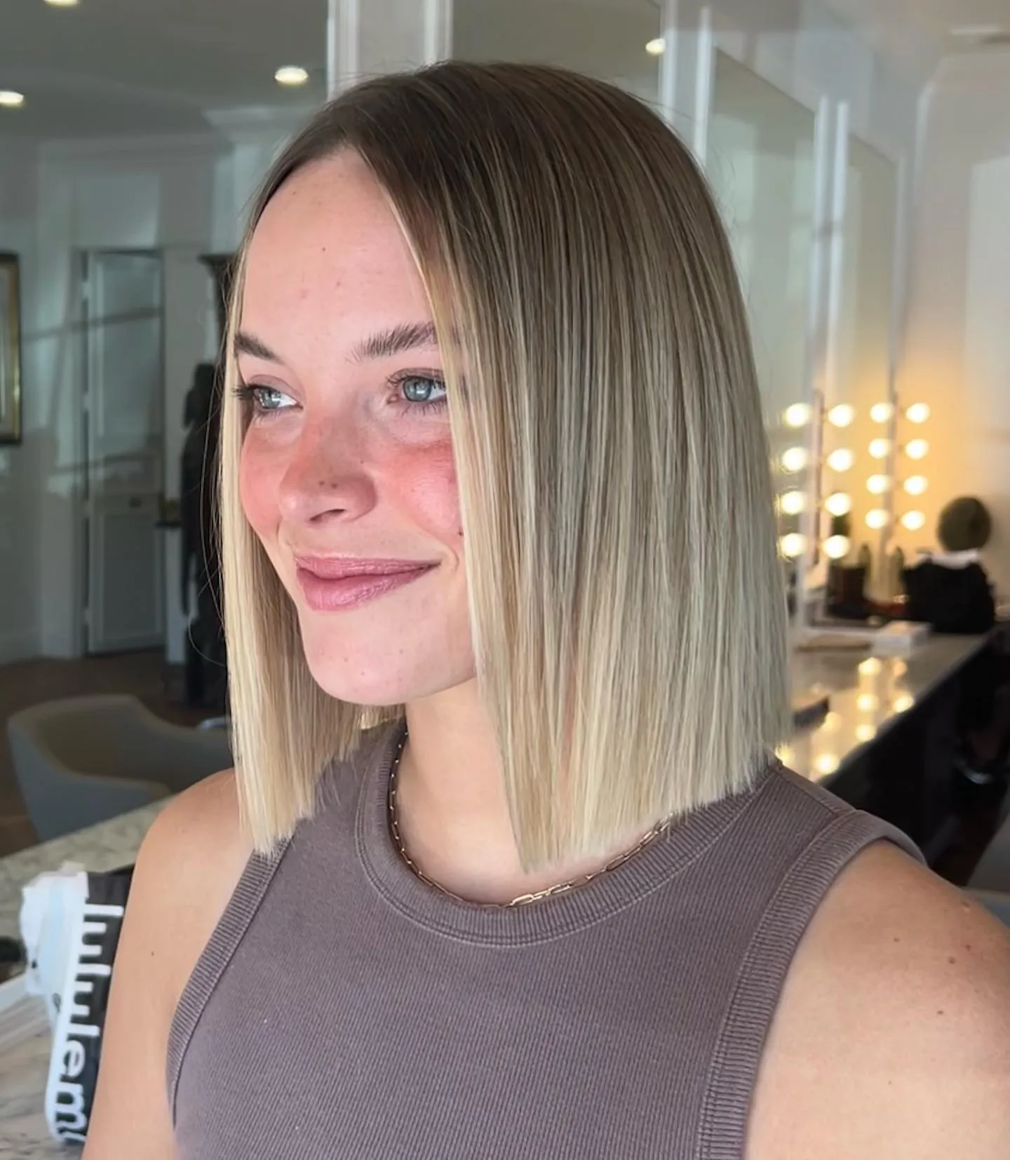 Straight center-part blunt bob with dark roots and light ends