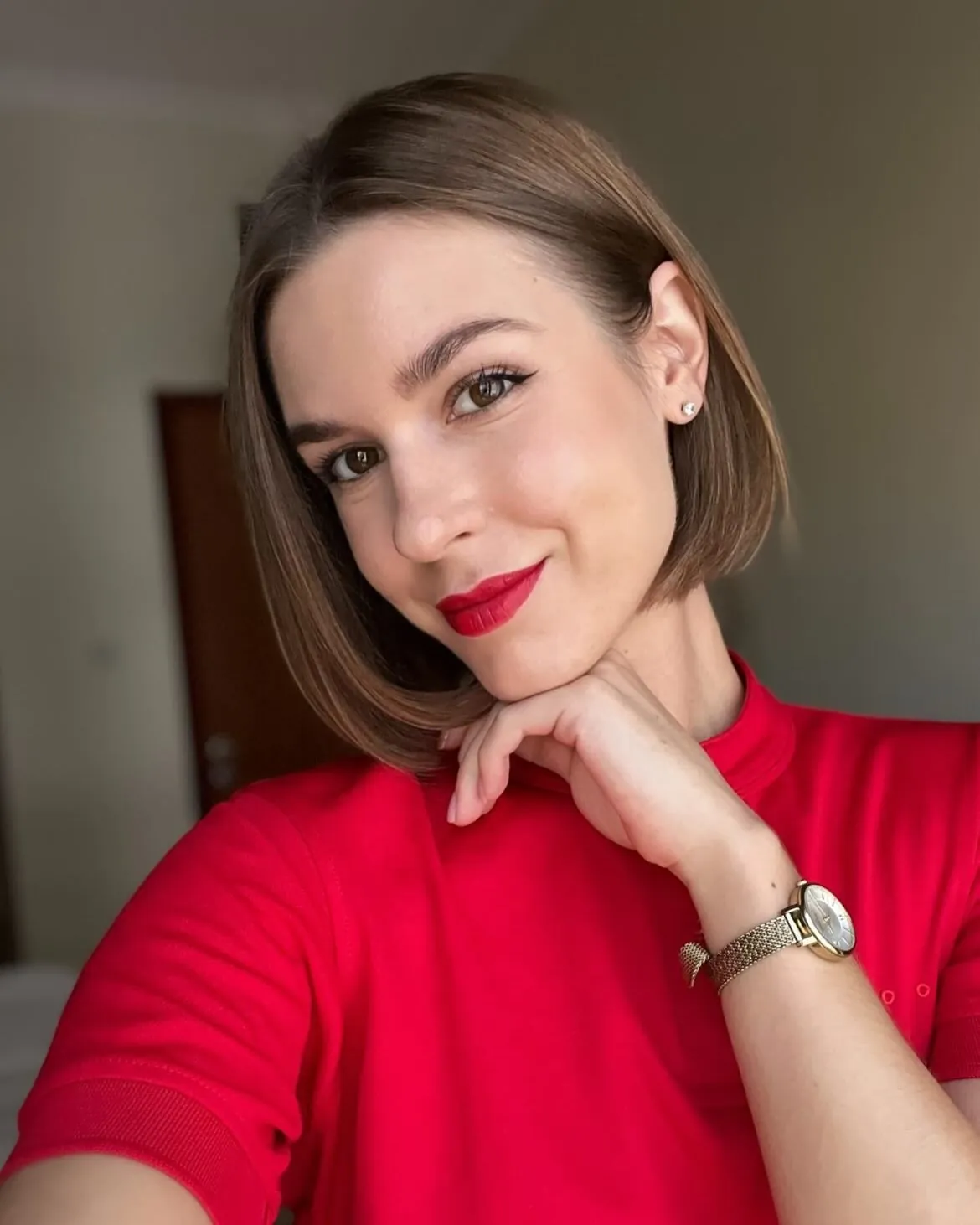 Sleek brunette bob with a deep side part and one side tucked back