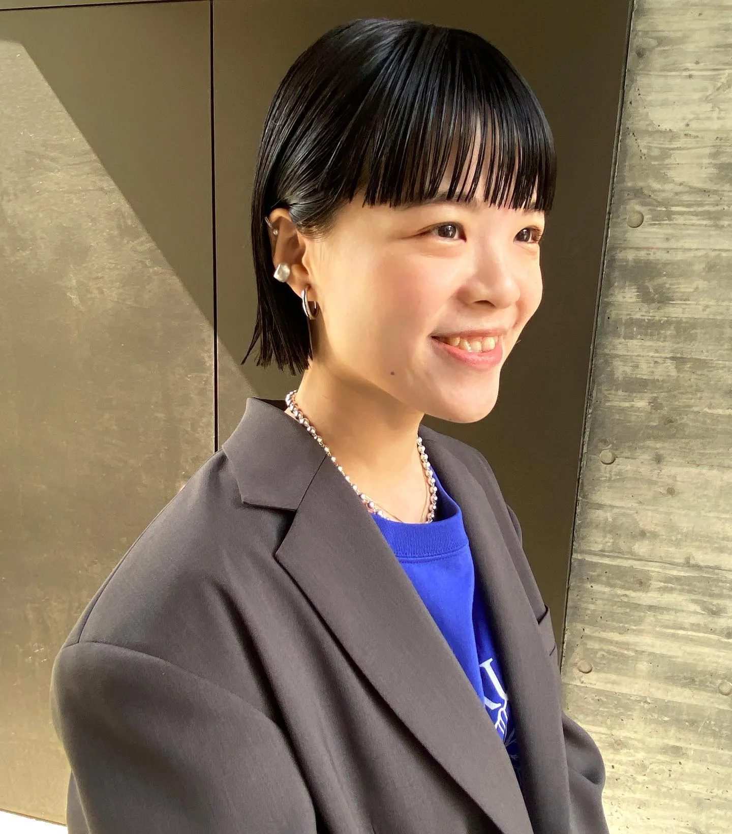Short black bob with a blunt fringe and sides tucked behind the ears