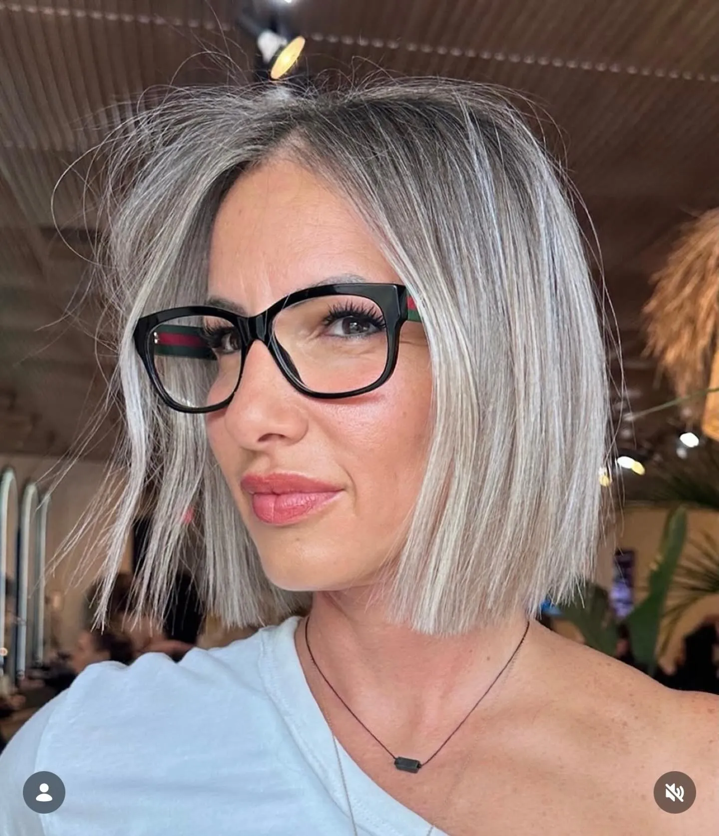 Silver blunt bob with a soft side part and straight shoulder-length ends