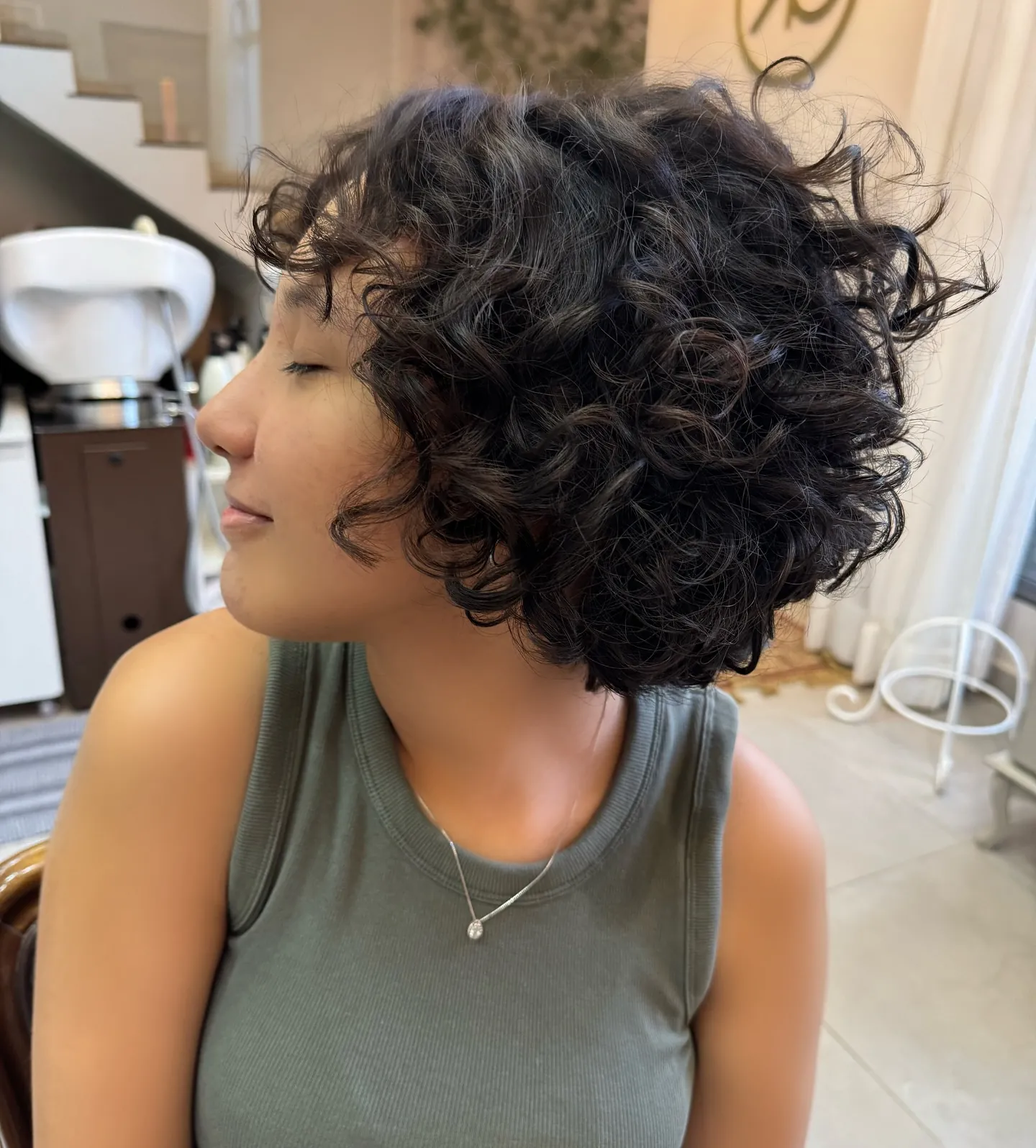 Short curly square bob with dense defined curls around the jaw