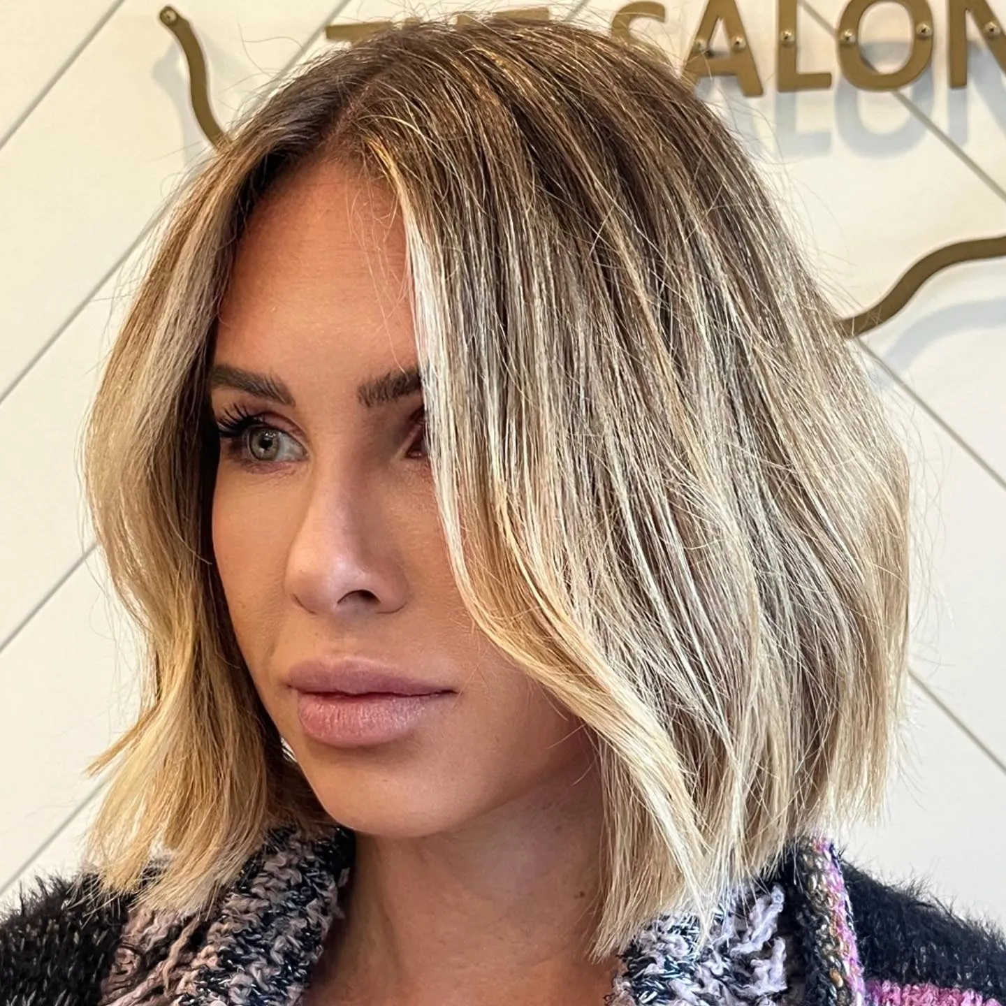 Textured blonde bob with a center part and loose bends