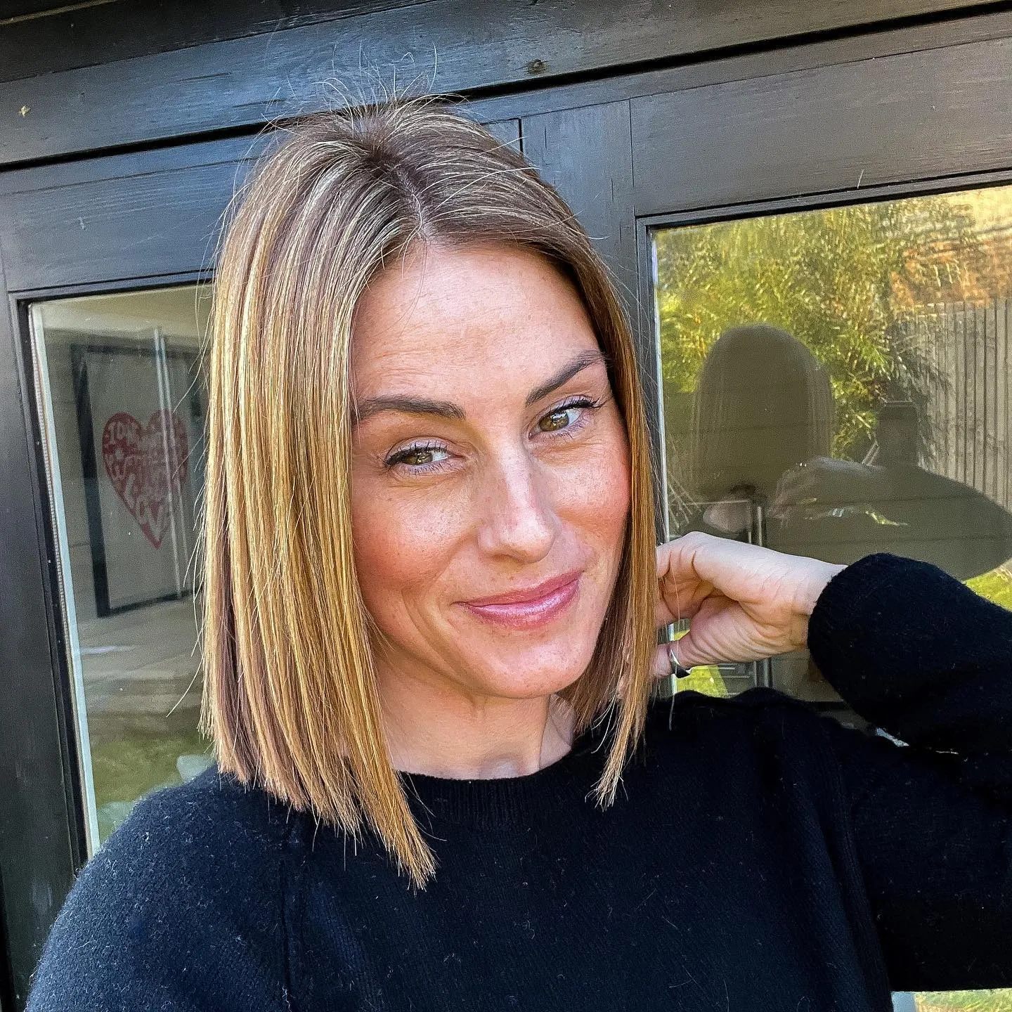 Straight blonde highlighted long bob with a centre part