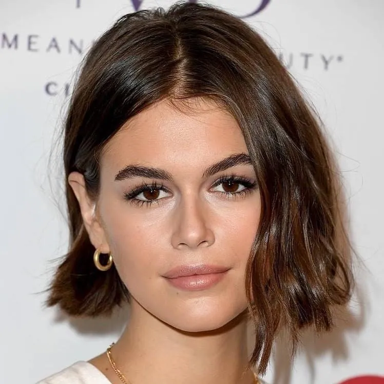Brunette straight bob with a centre part and softly flipped ends