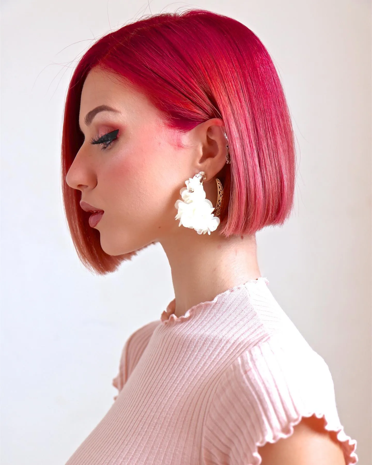 Vivid pink straight blunt bob with a sleek side part