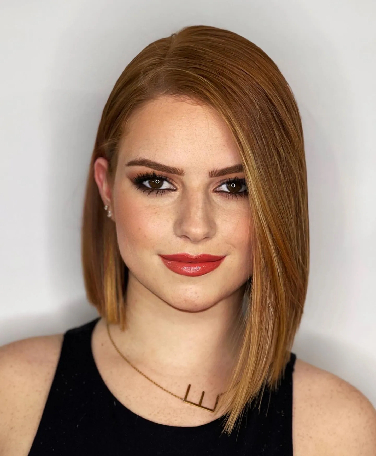 Copper straight bob with a deep side part and longer angled front