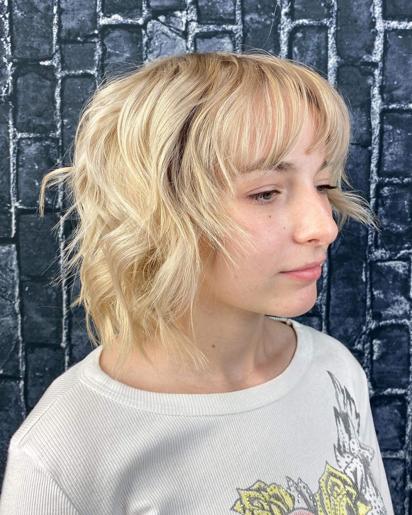 Choppy wavy bob with wispy fringe and uneven textured ends