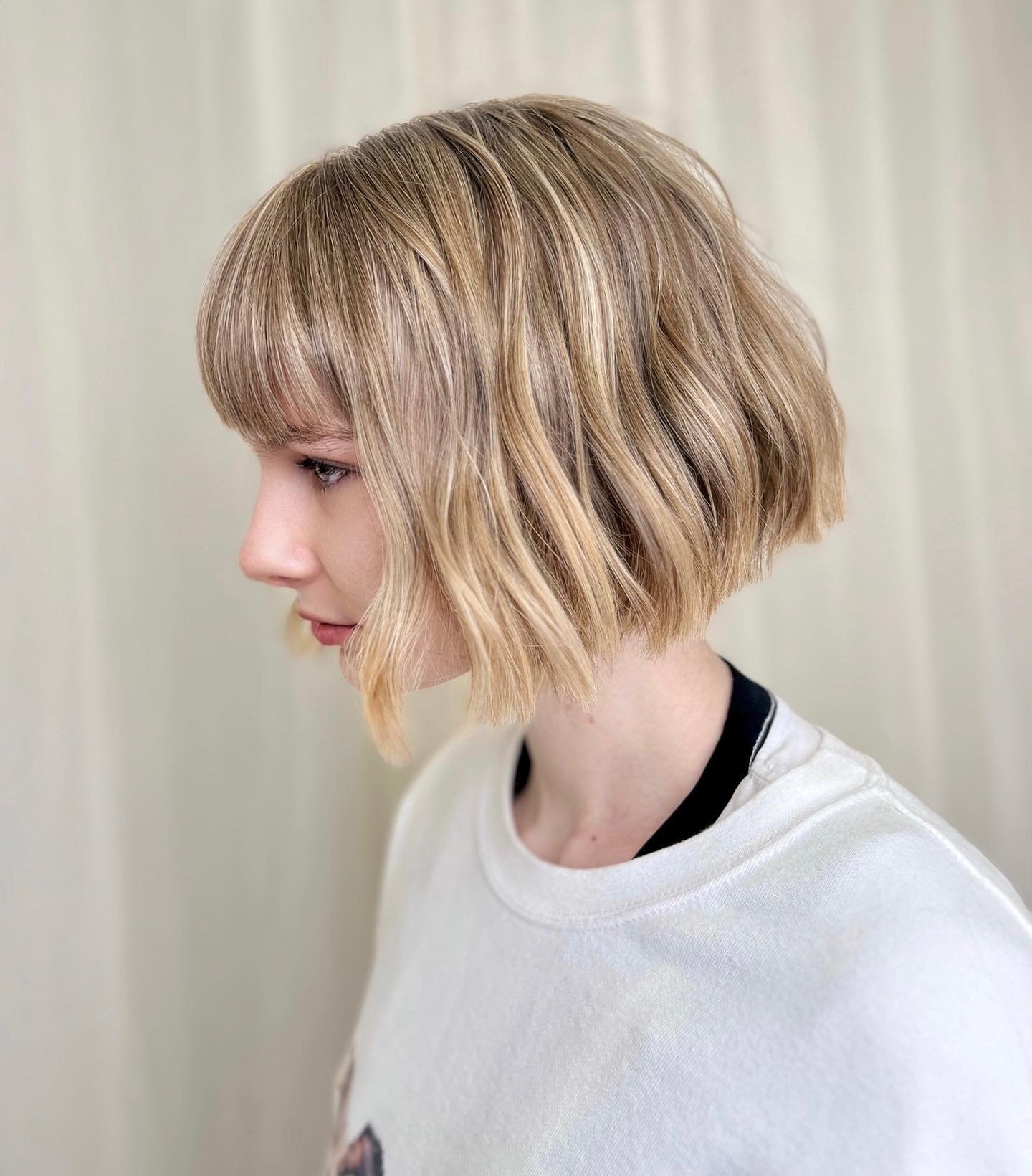 Angled tousled bob with side-swept fringe and textured ends
