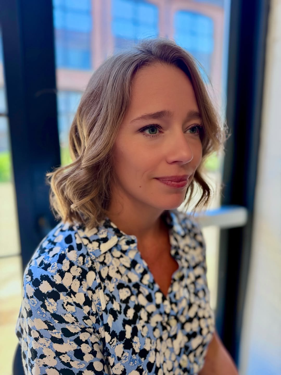 Side-parted bob with loose curled ends and soft face framing