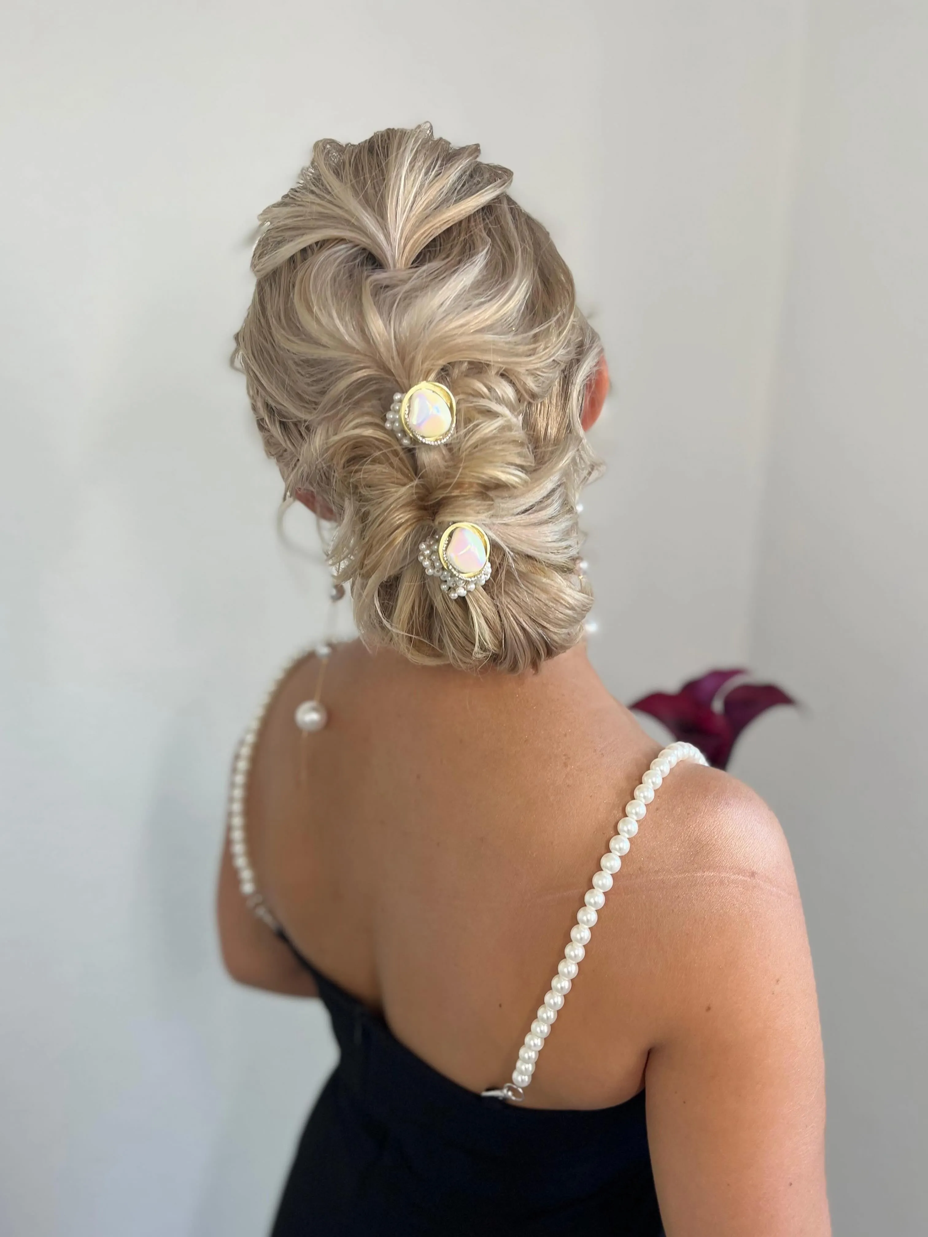Sculpted looped bridal updo for short blonde hair with decorative pins