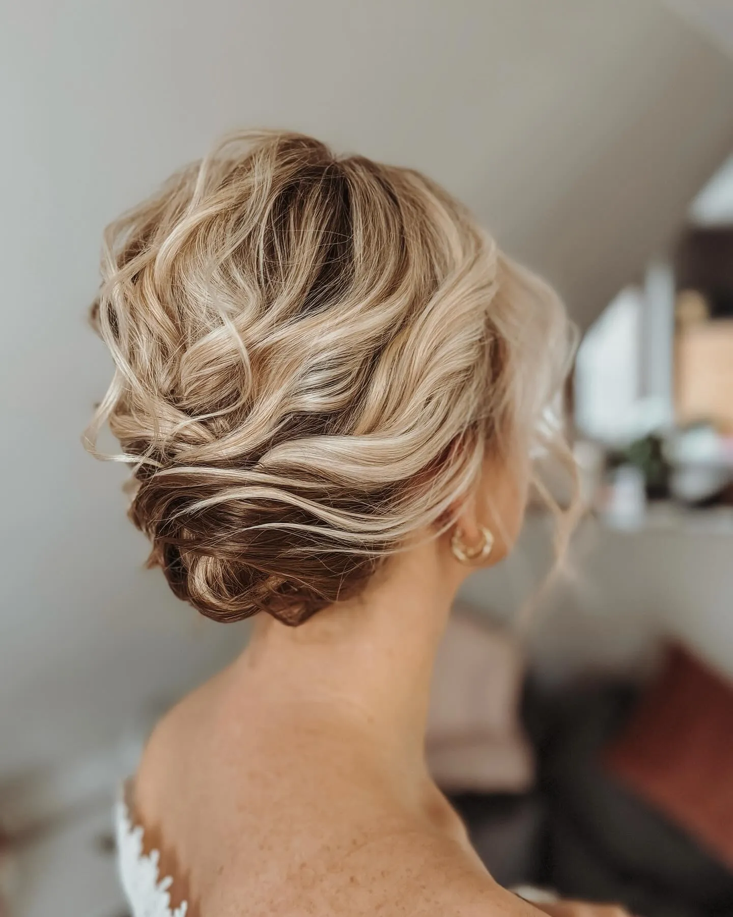 Soft wavy low updo for short blonde hair