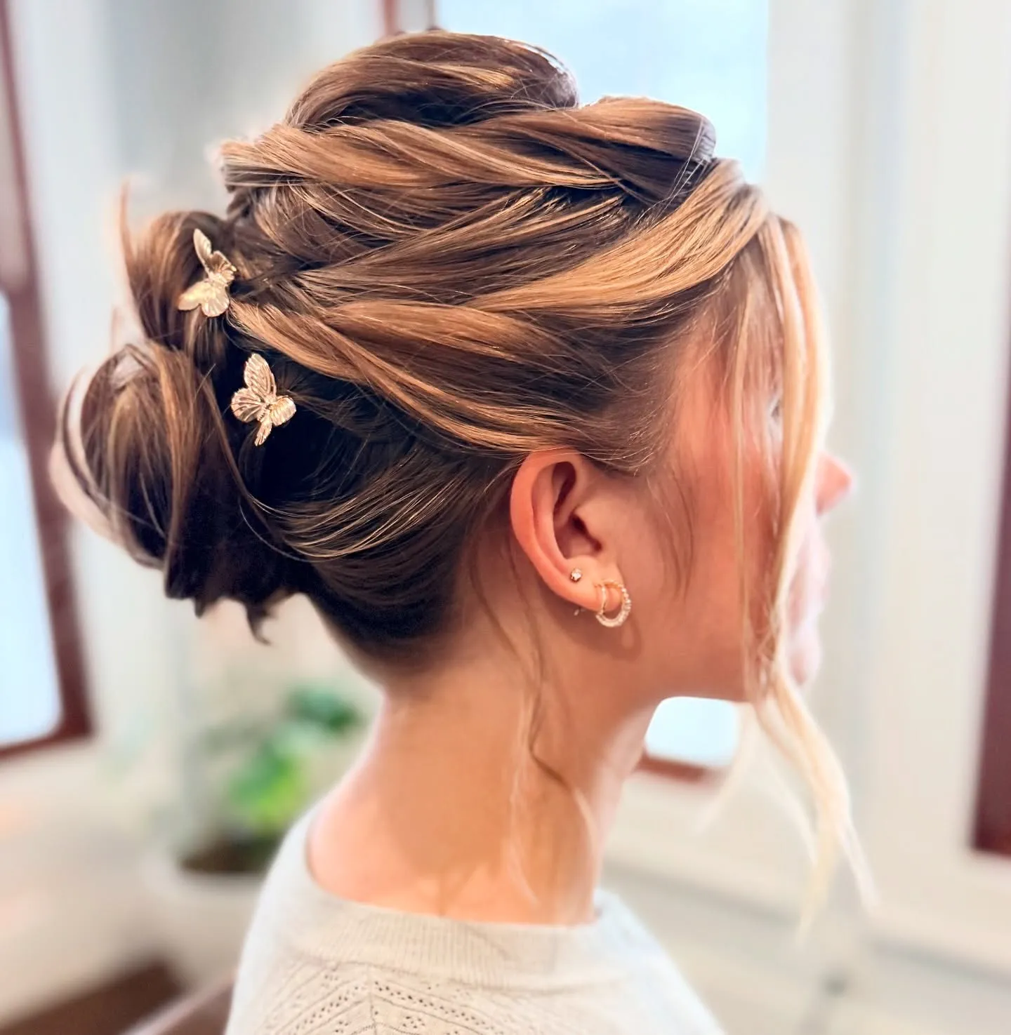 Braided low bun for short hair with small floral pins