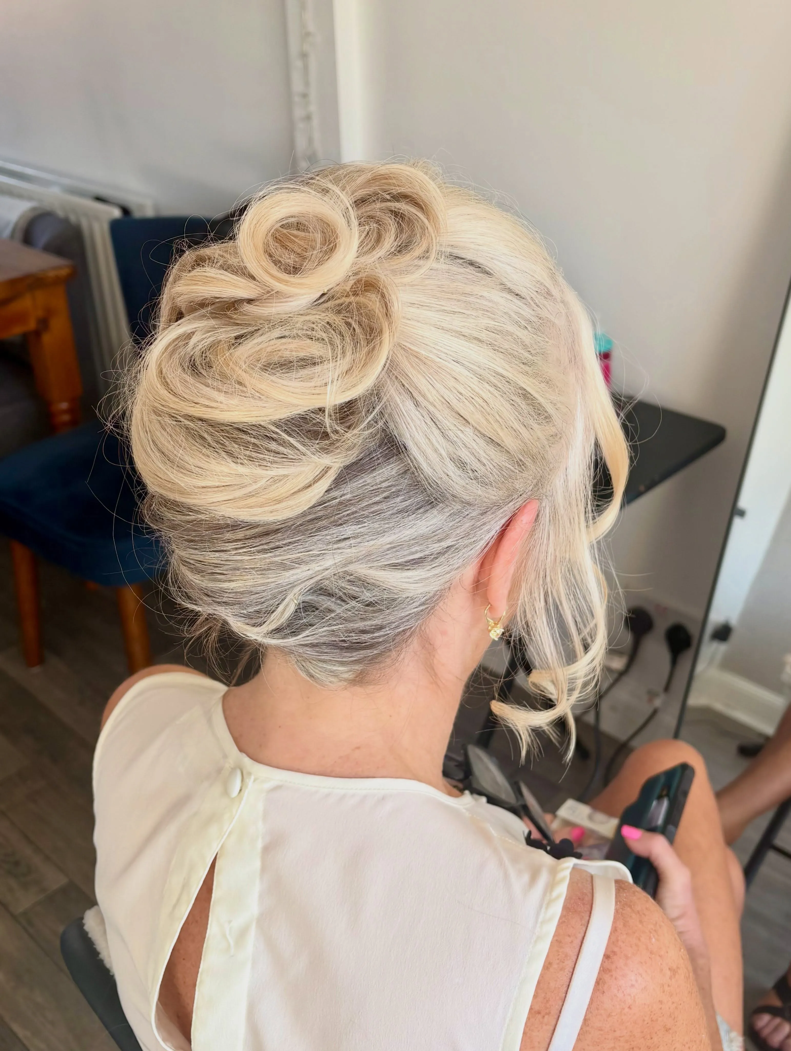 Voluminous pinned curl updo for short silver blonde hair