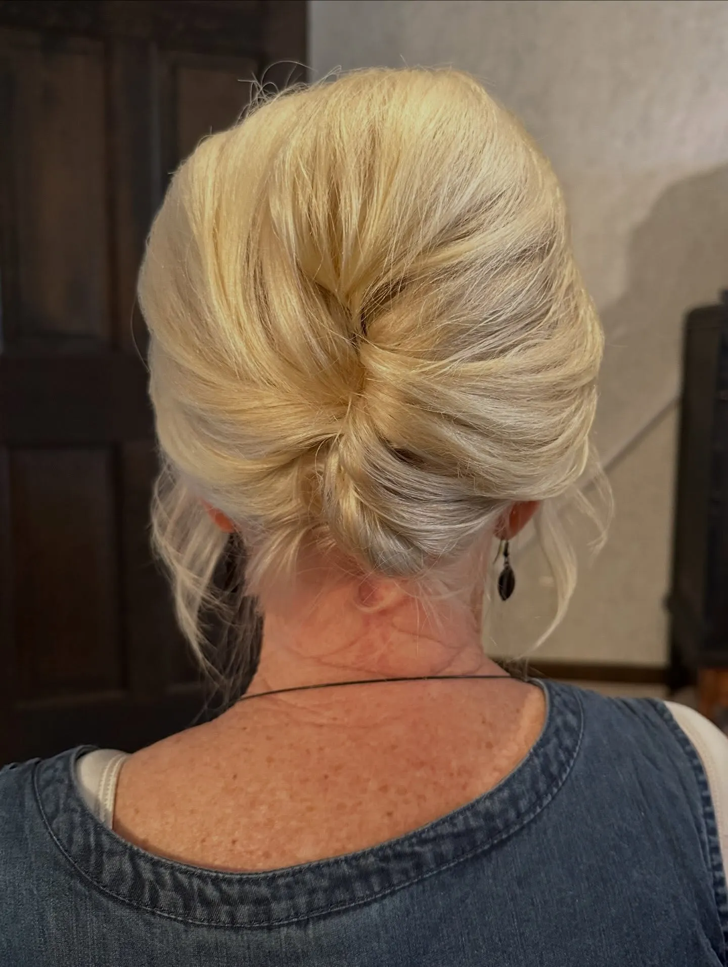 Sleek folded low chignon for short blonde hair