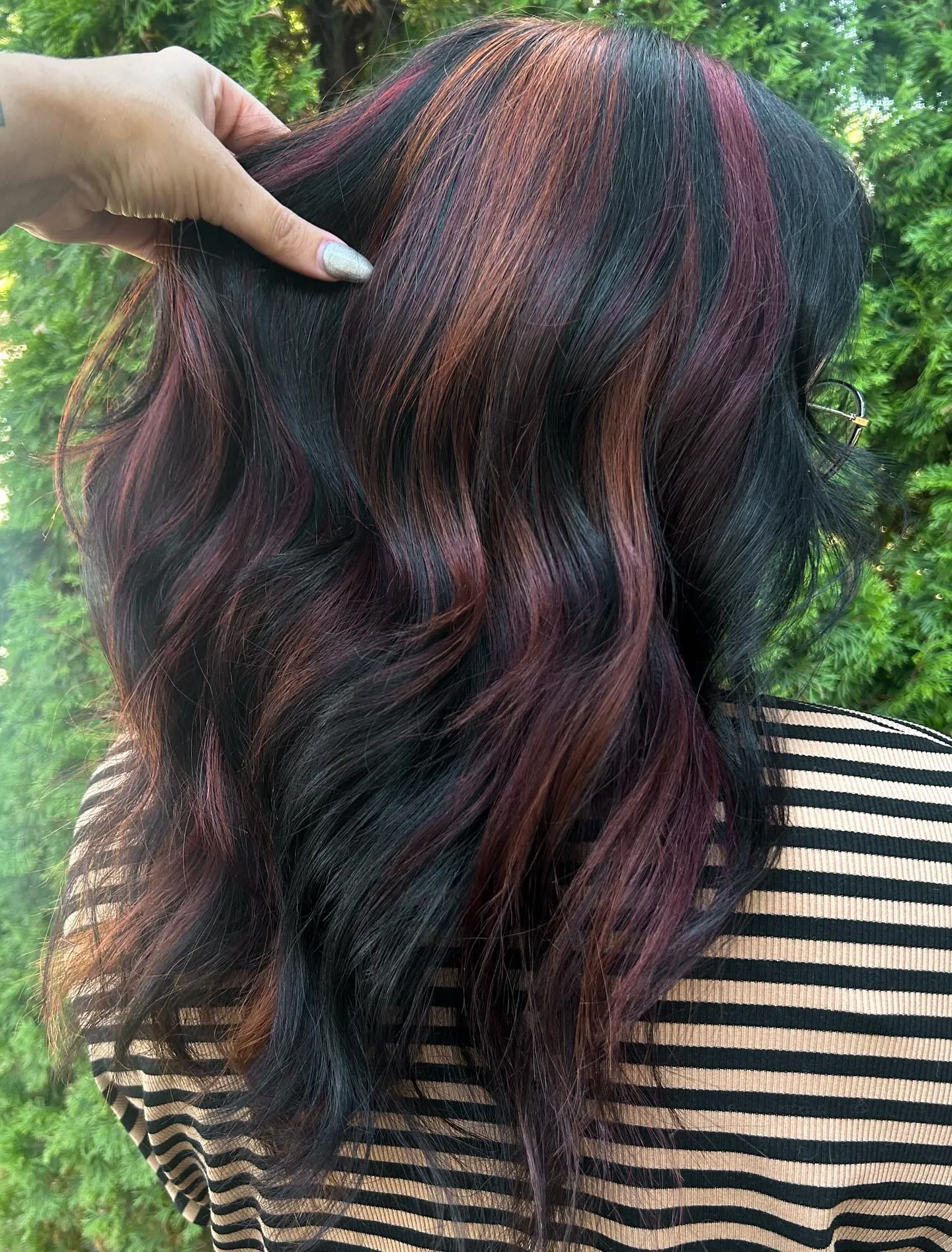 Black wavy hair with burgundy ribbon highlights