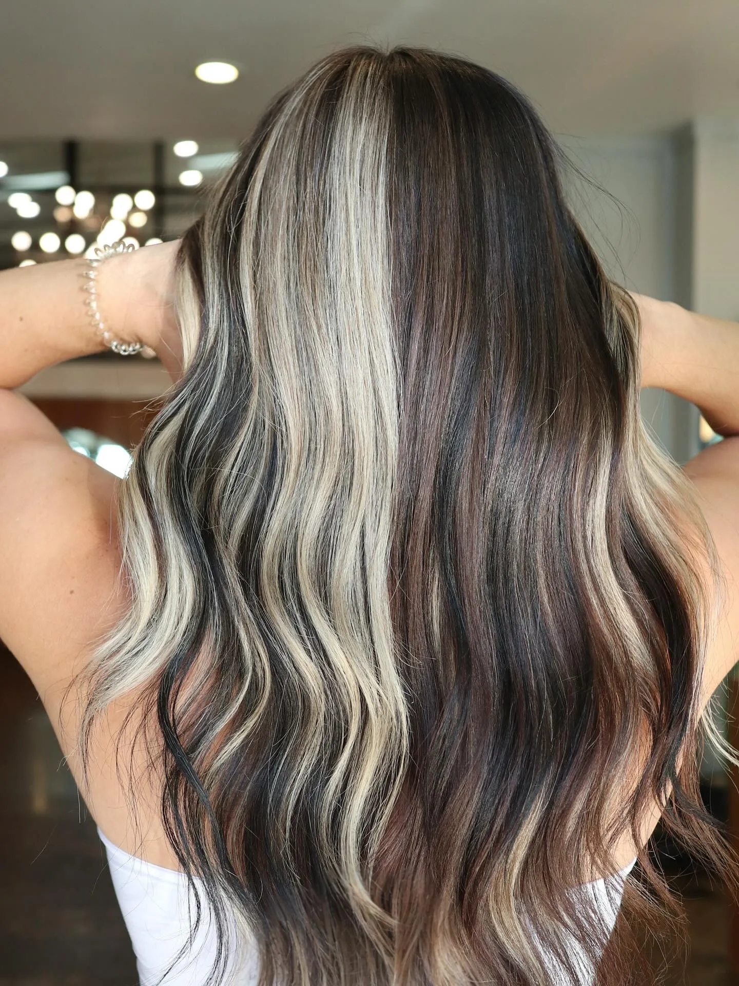 Dark brunette waves with wide cool blonde highlights
