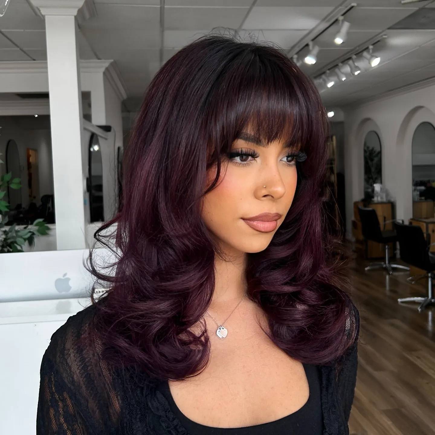 Deep violet layered hair with full fringe