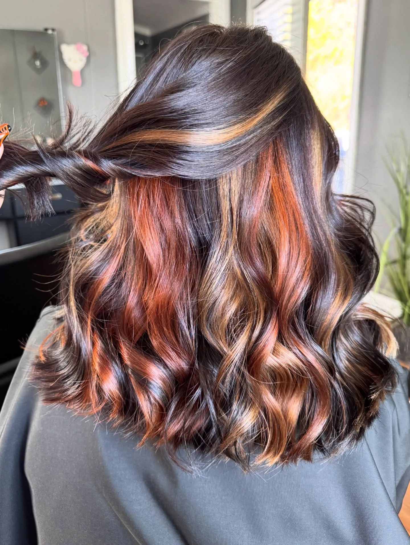 Brunette waves with copper peekaboo highlights