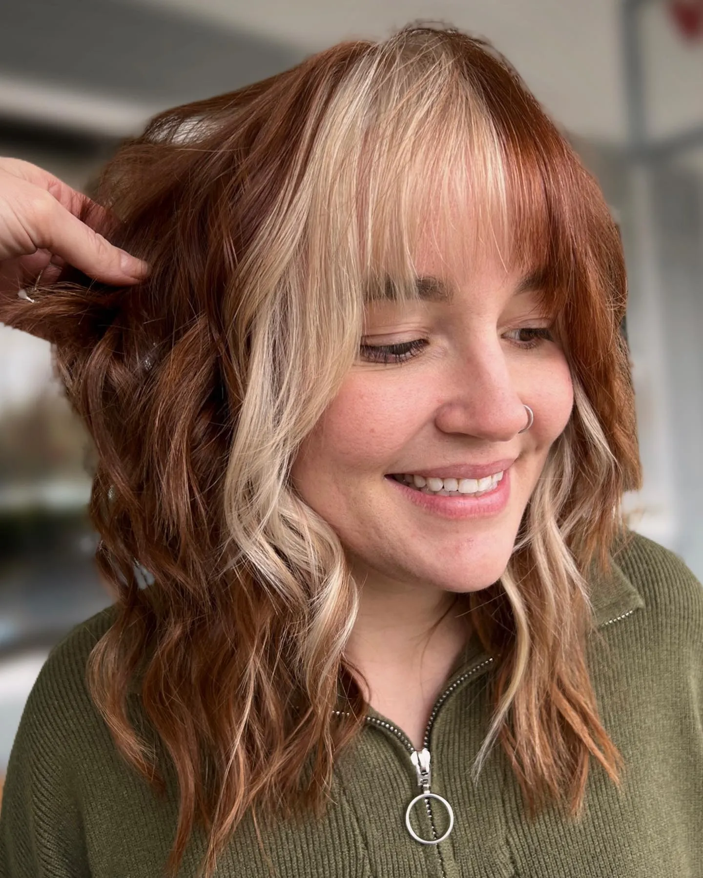 Warm brunette waves with pale blonde face-framing pieces