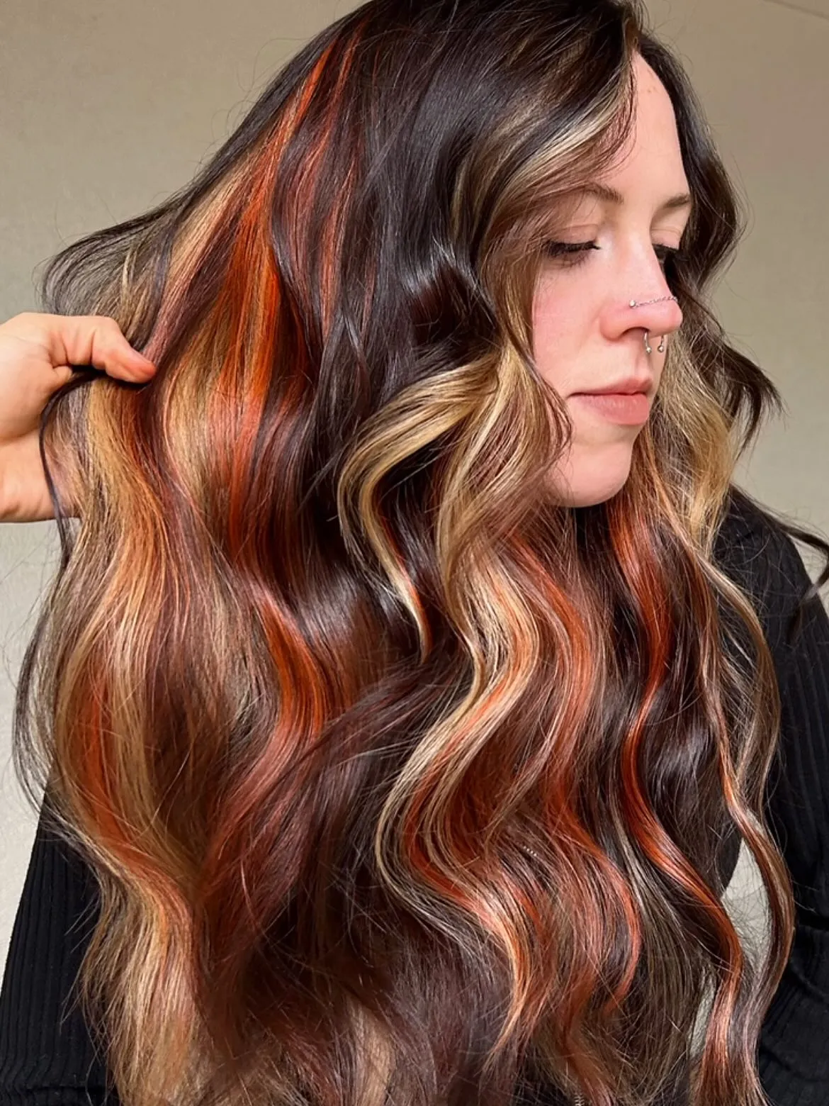 Dark brunette waves with orange and blonde ribbon highlights