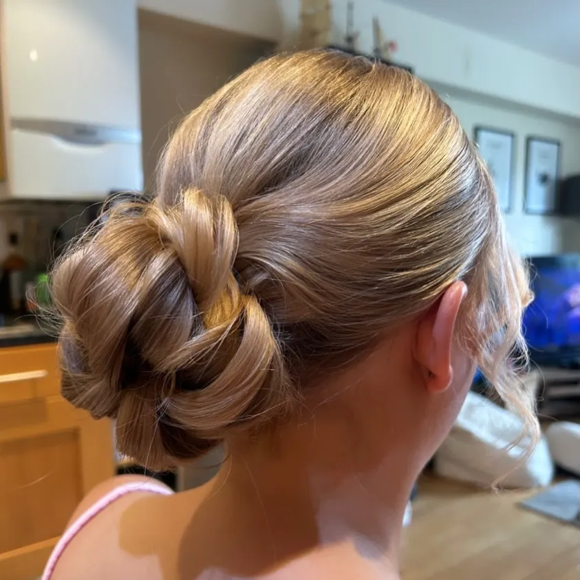 Sleek low loop bun with centre part