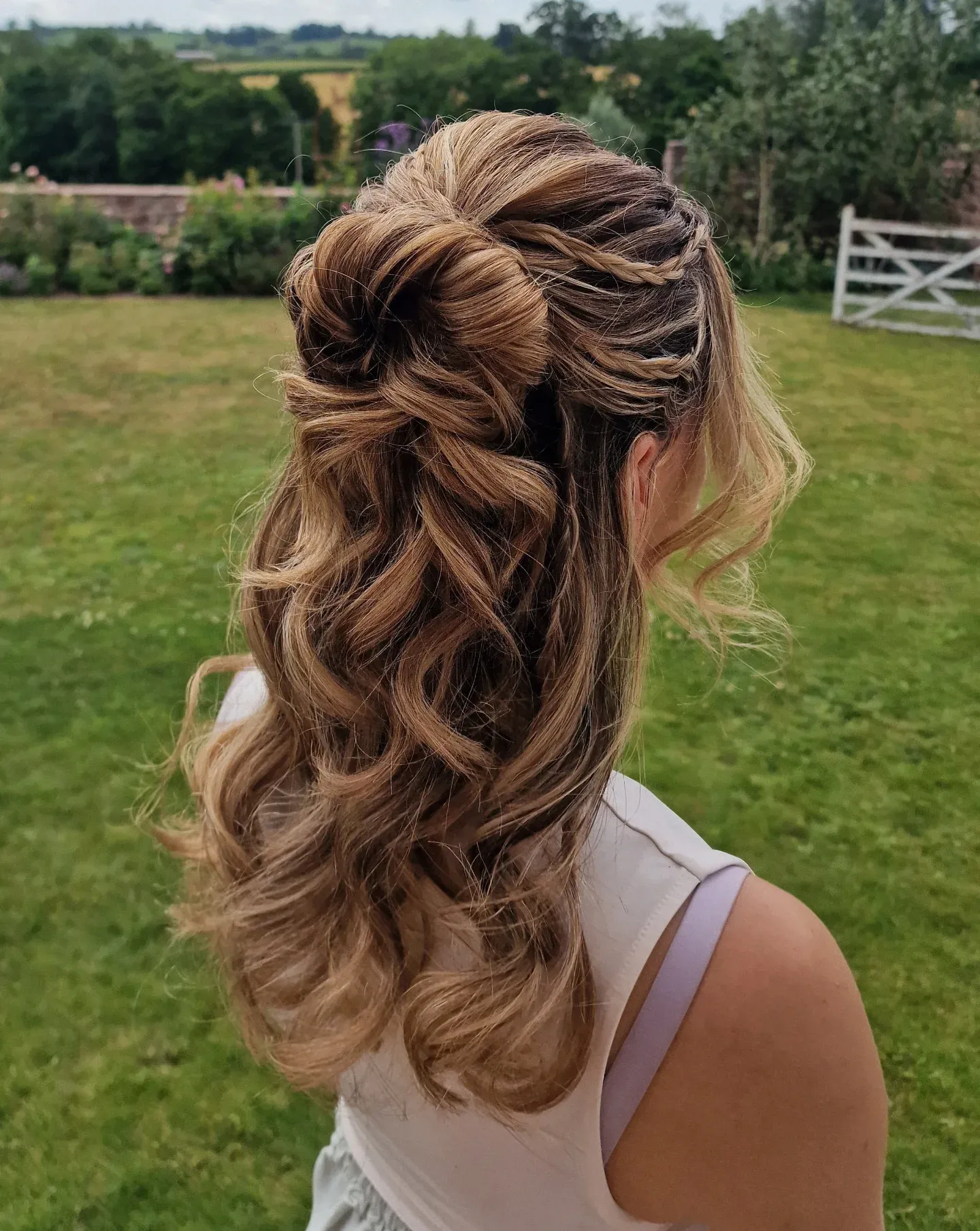 Braided half-up ponytail with long curls