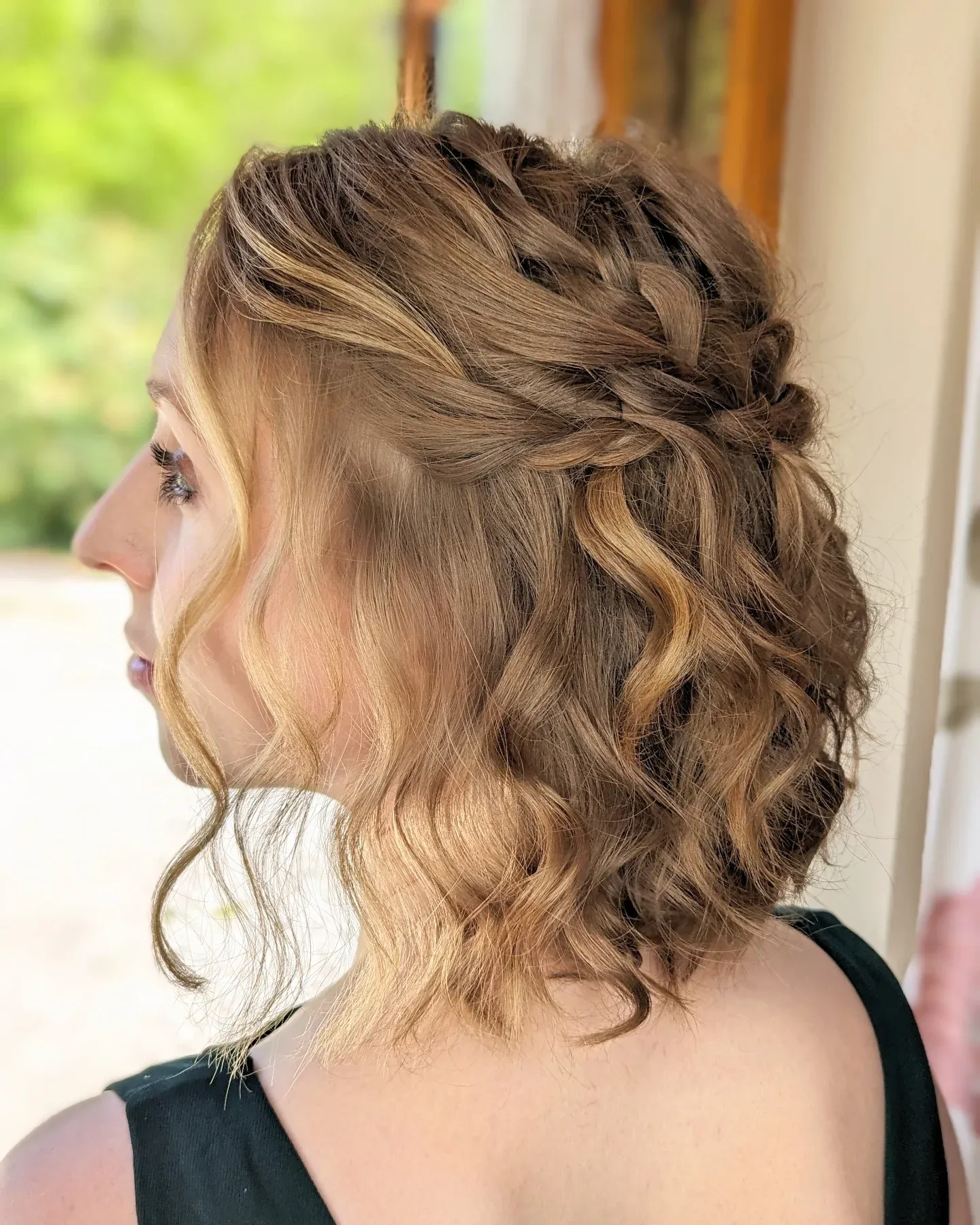 Side-braided half-up hairstyle with loose waves