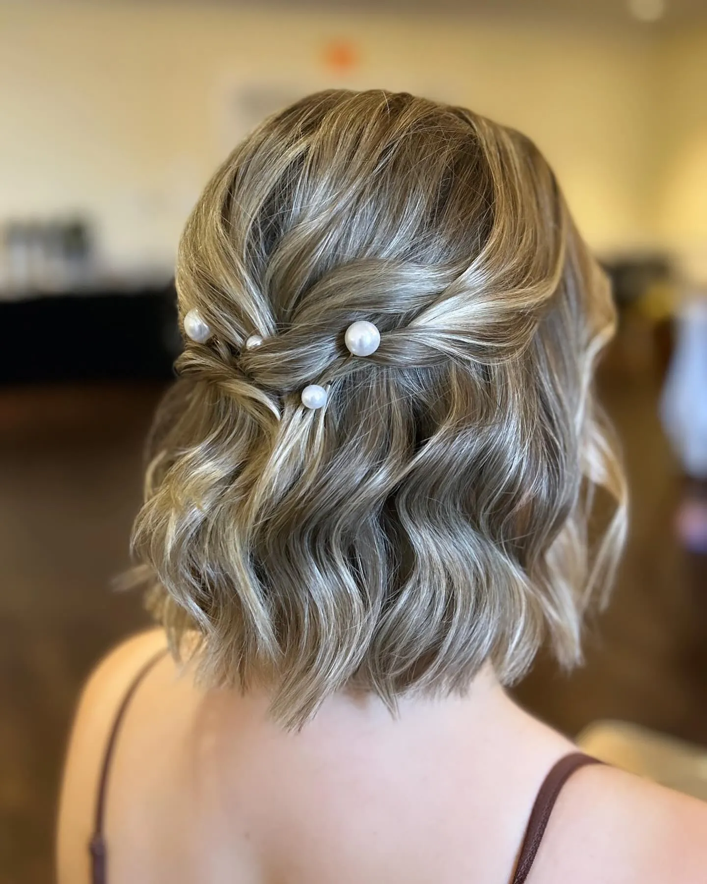 Wavy half-up bob with pearl pins