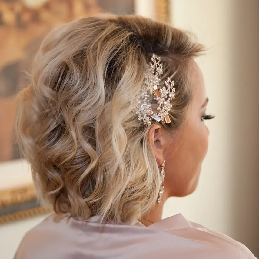 Side-swept curly bob with floral clip