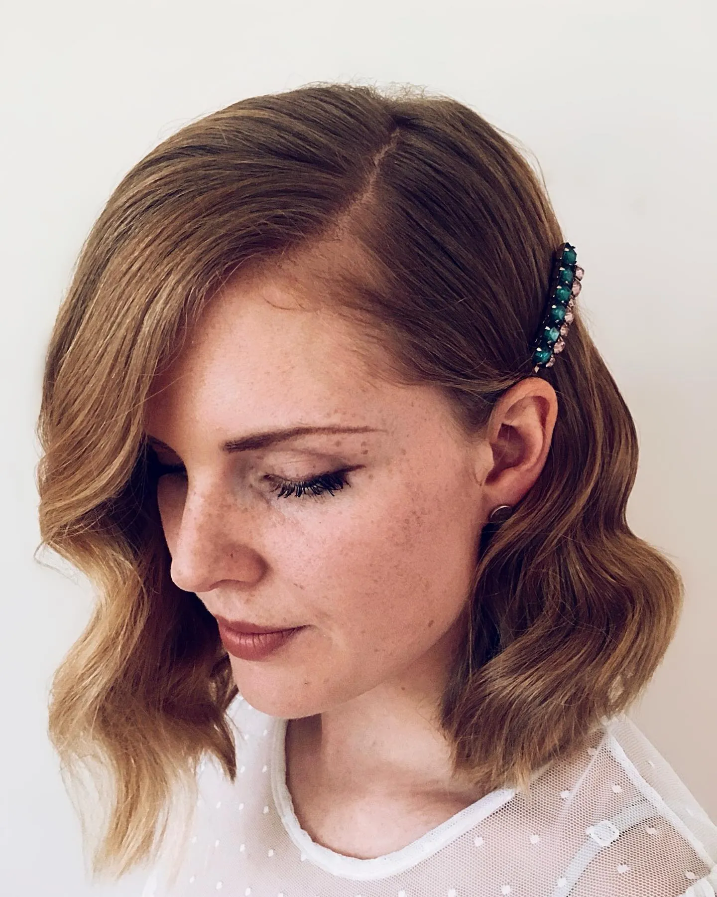 Side-swept wavy bob with decorative hair clip