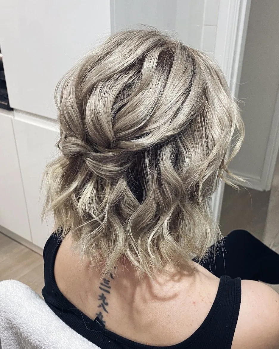 Wavy bob with overlapping half-up twists
